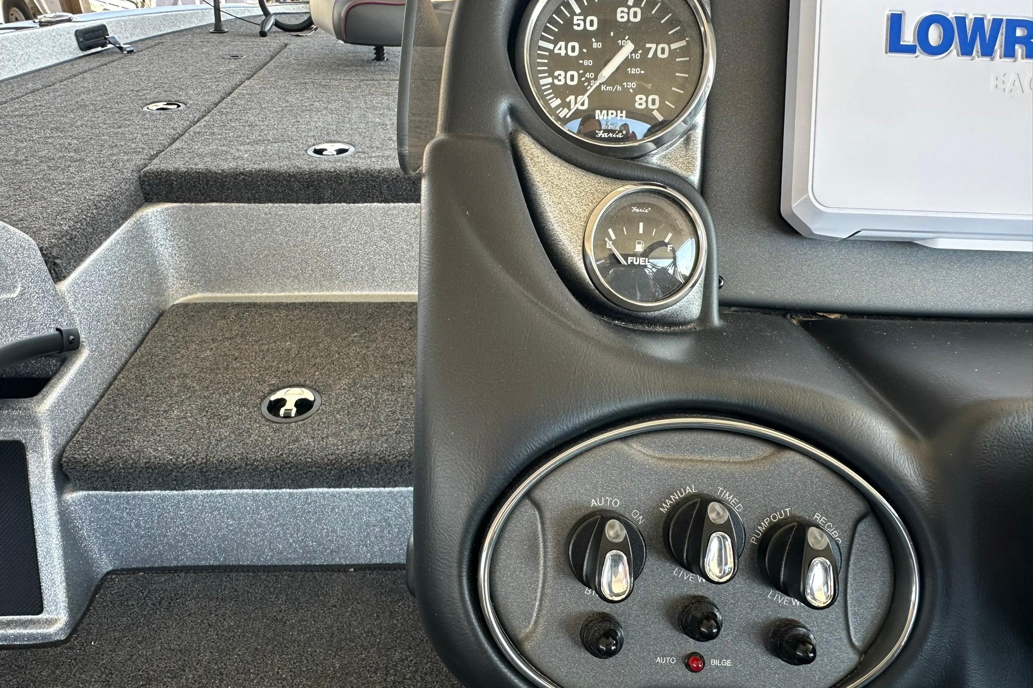 2026 Triton 179 TrX boat dashboard with gauges and control switches.