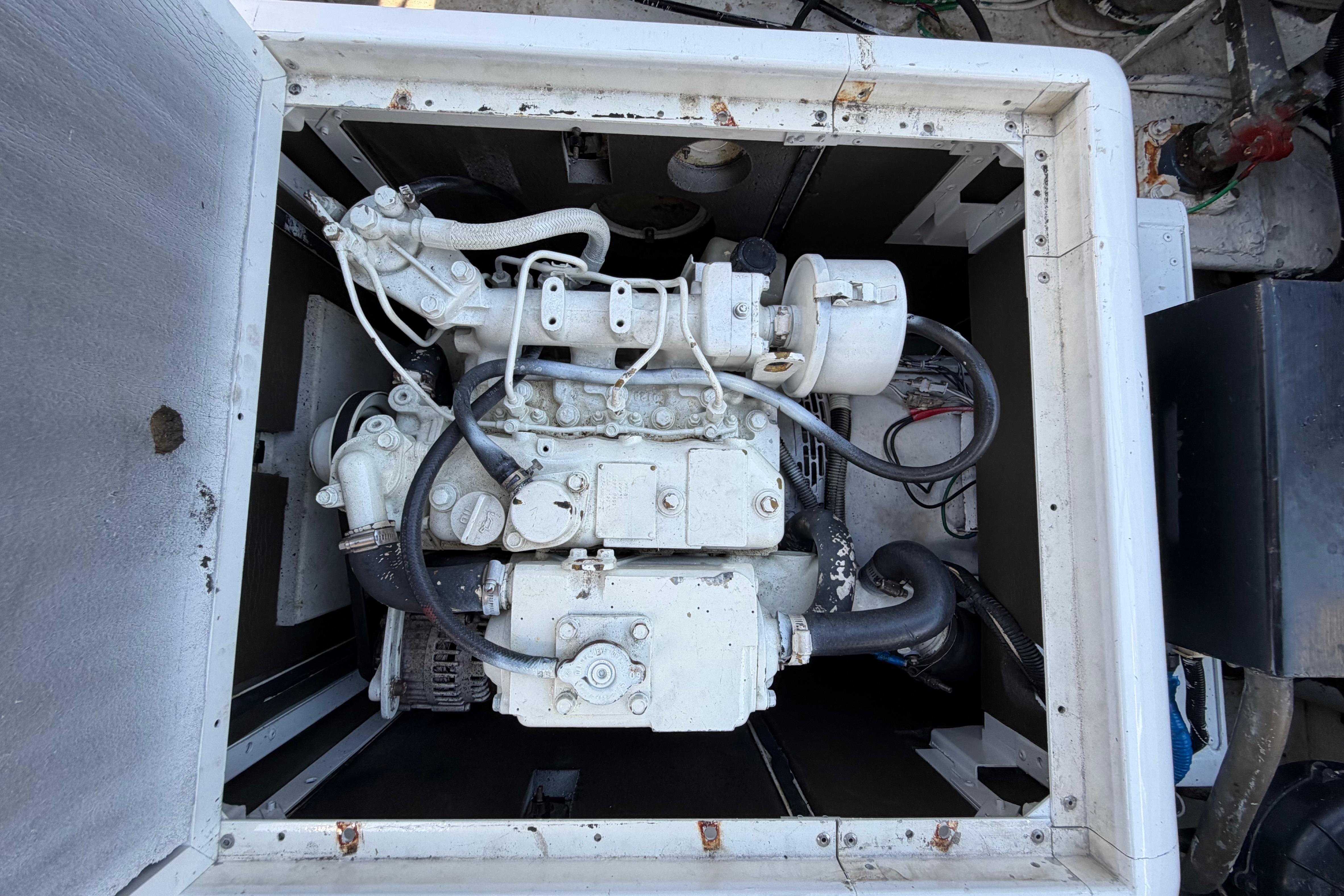 Engine compartment of a 1986 Bertram 46 Convertible boat, showcasing mechanical components.