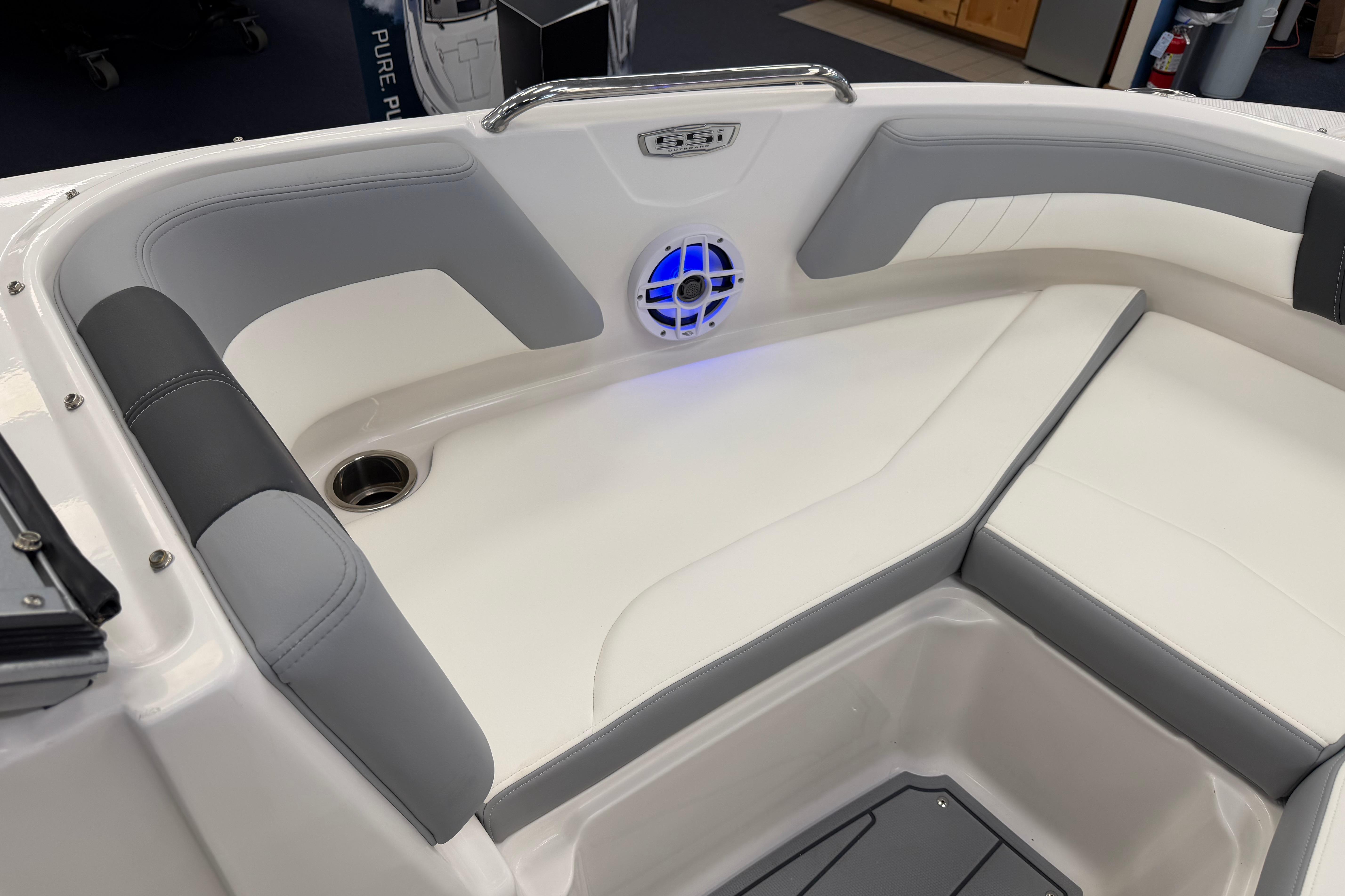 Interior seating of 2025 Chaparral 21 SSi OB boat with speaker and cup holder.