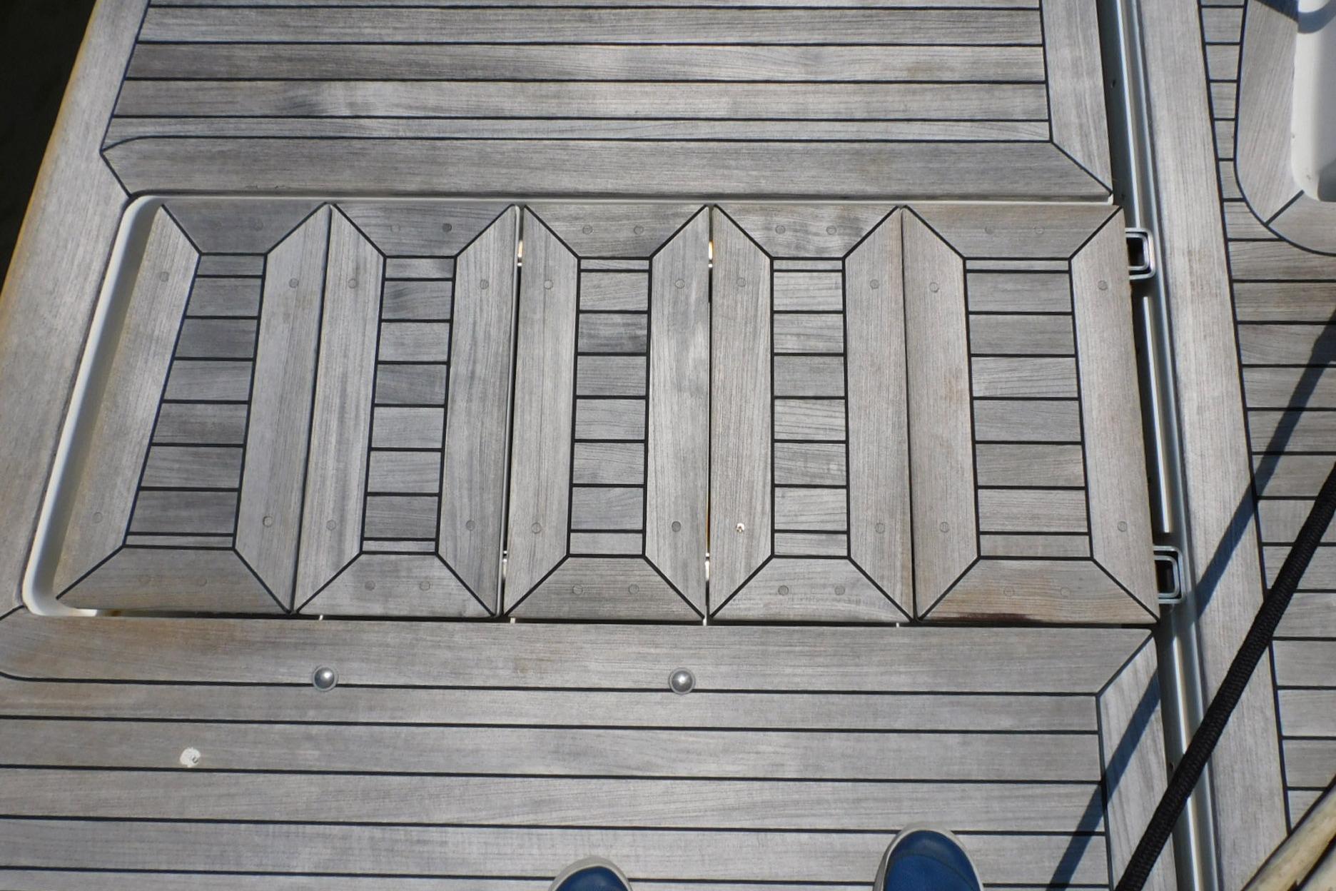 Teak deck of 2019 Sea Ray L550 yacht, showcasing intricate wood pattern.