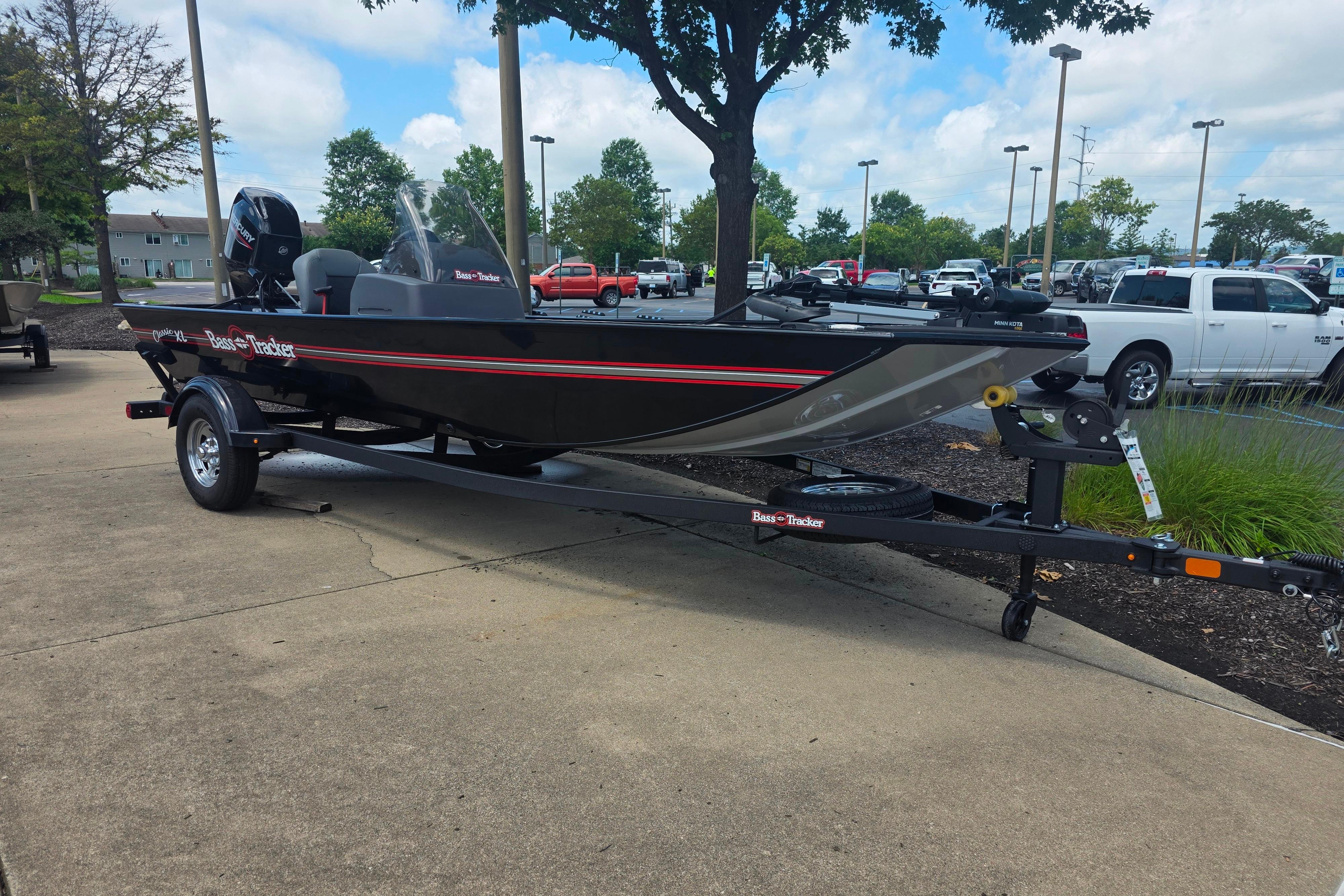 2026 Tracker Bass Tracker Classic XL boat on trailer in parking lot.