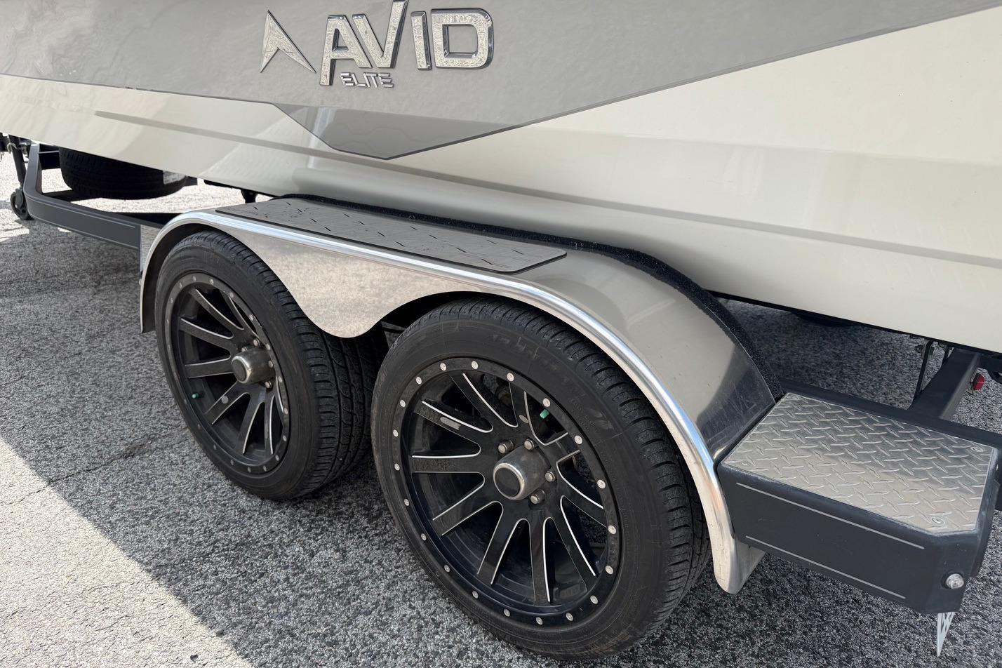2024 Avid 21 XB Elite boat trailer with sleek black wheels and metallic fenders.