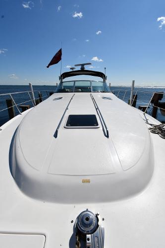 1997 Sea Ray 400 Sundancer yacht docked under clear blue sky.