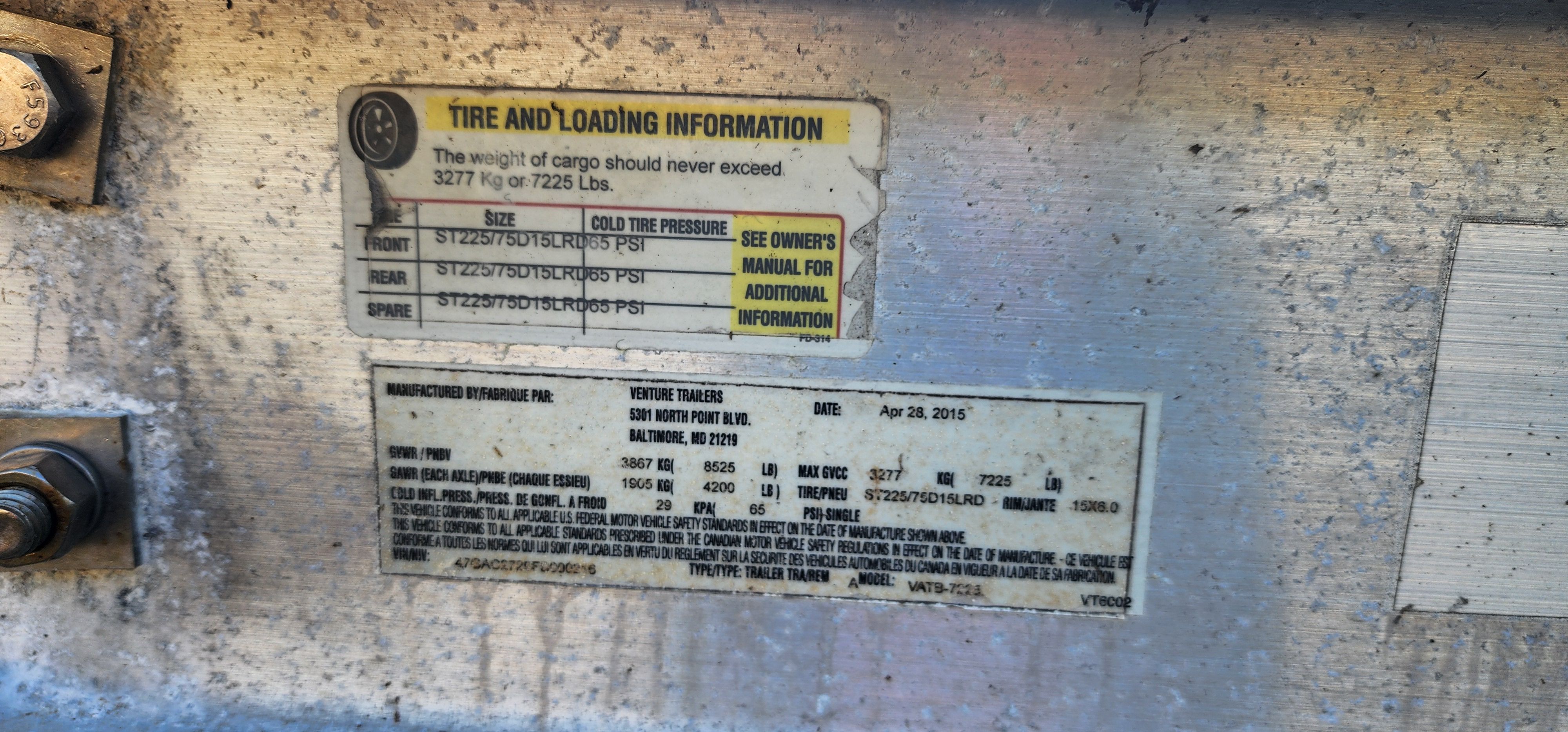 A label on a boat showing tire and loading information along with manufacturing details.