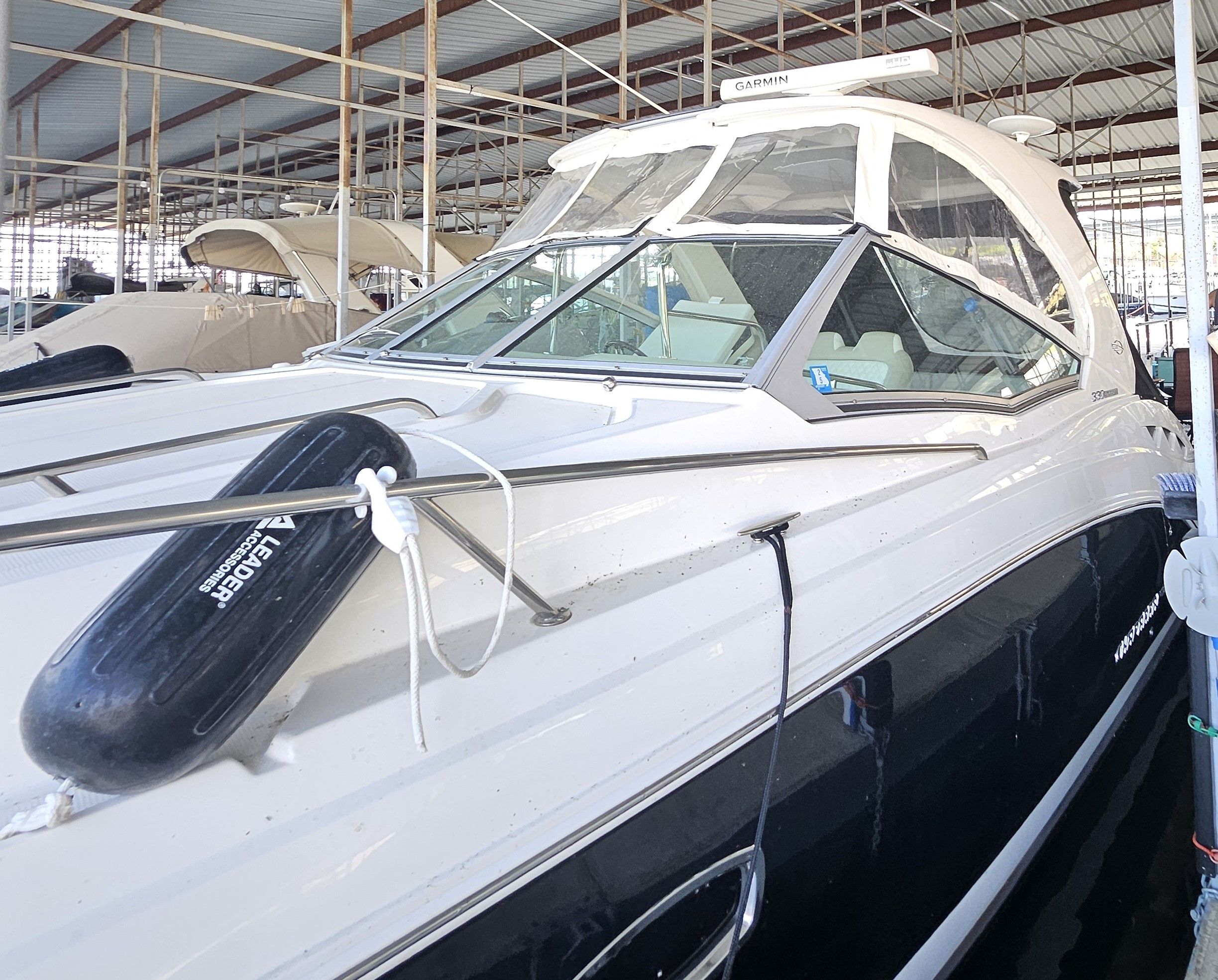 2014 Chaparral 330 Signature Yacht in covered marina.
