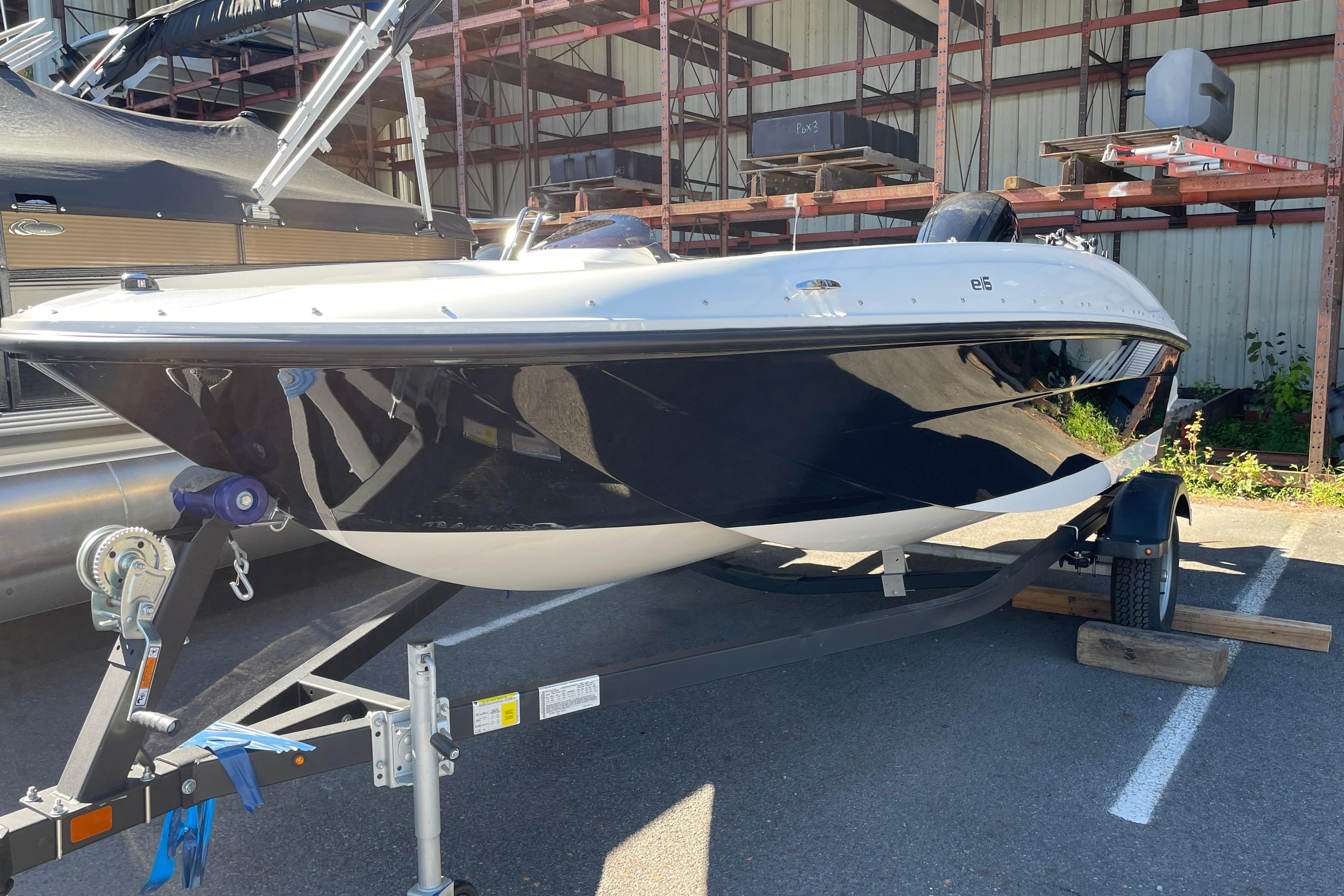 2026 Bayliner Element E16 boat on trailer in outdoor storage area.
