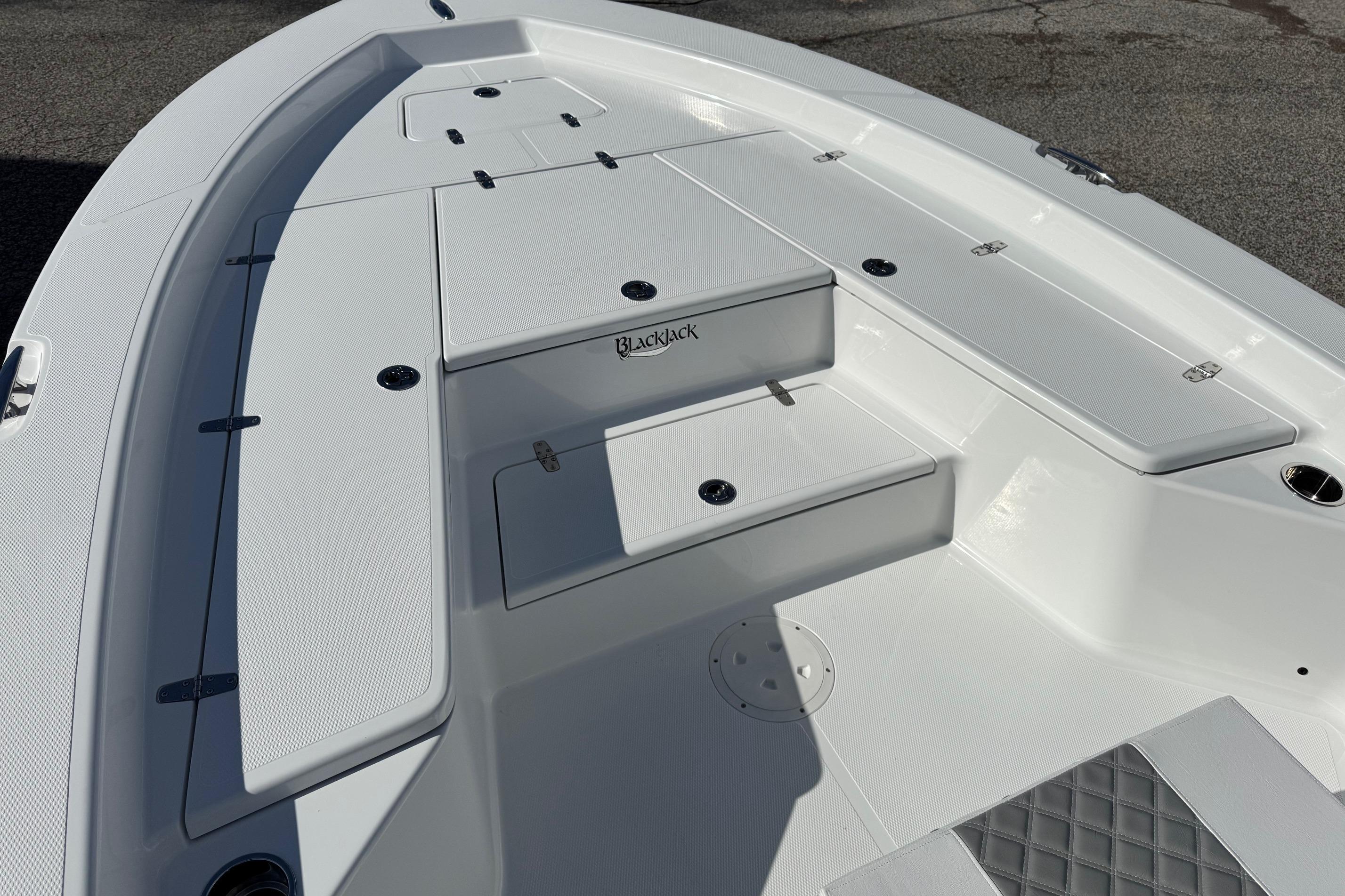 2026 BlackJack 256 Bay boat deck with storage compartments and seating.
