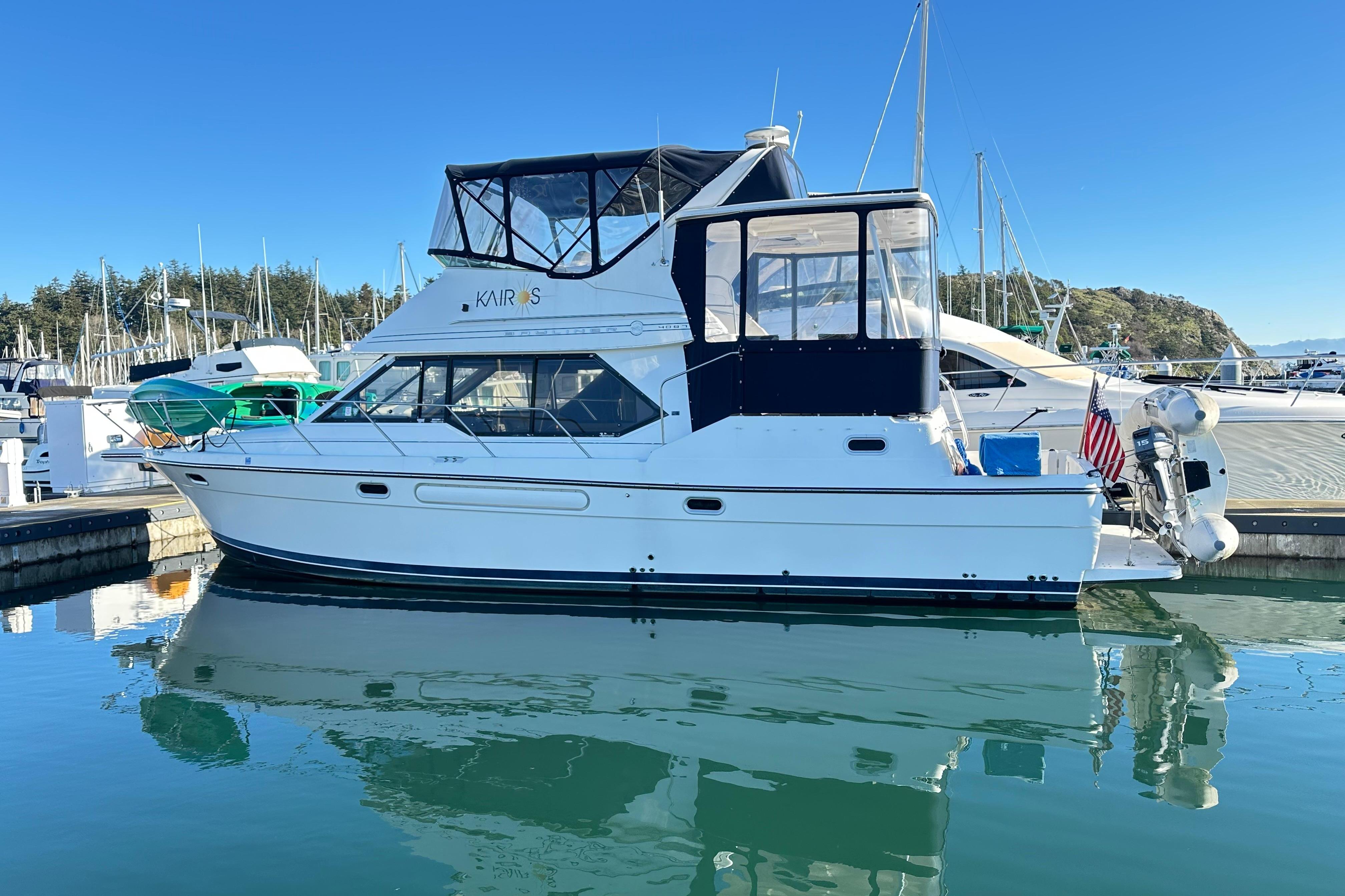 2000 Bayliner 4087 Aft Cabin Motoryacht docked in a marina under clear blue skies.