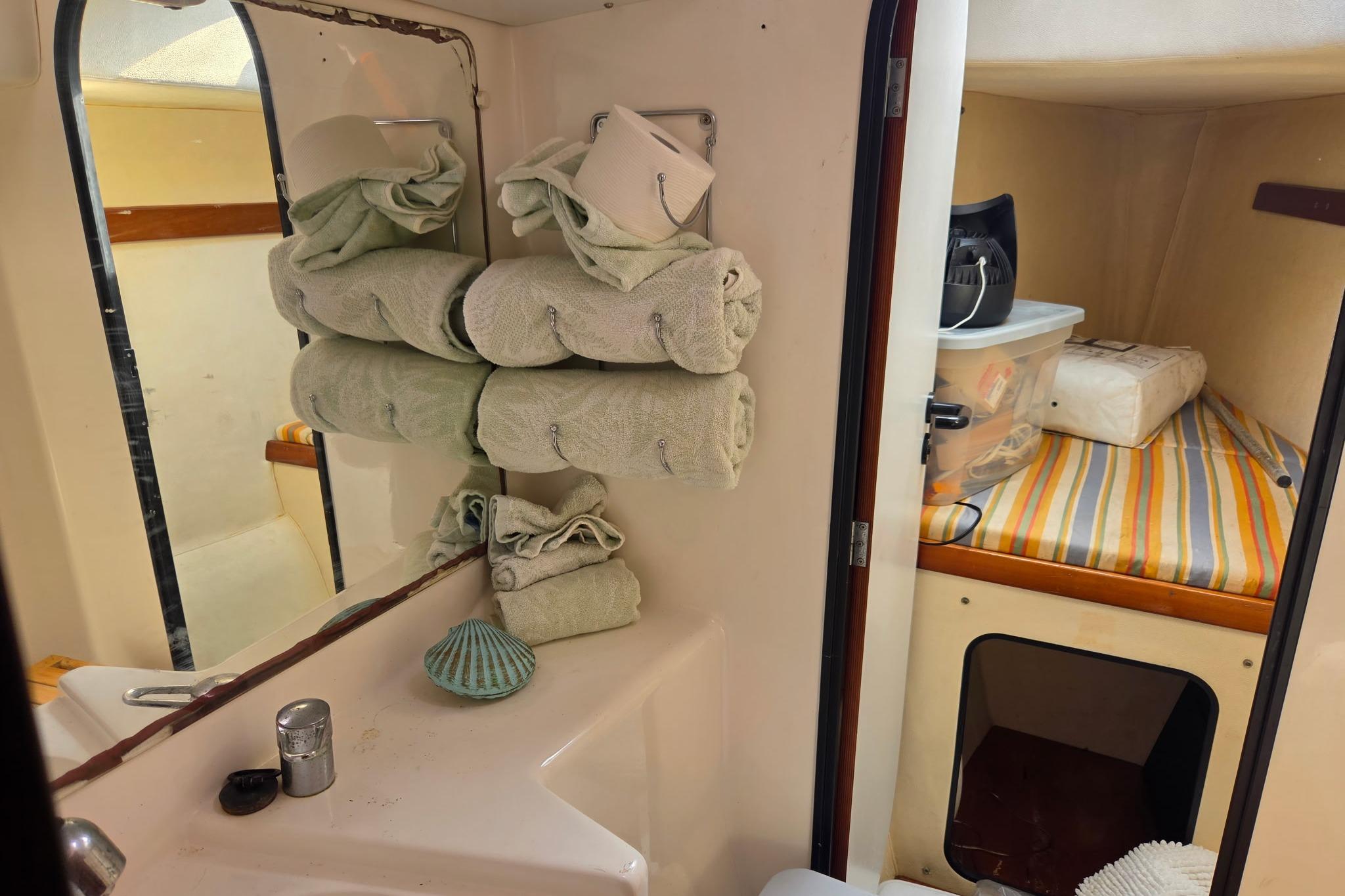 Bathroom and cabin interior of 2000 Fountaine Pajot Maryland 37 yacht, featuring towels and storage.