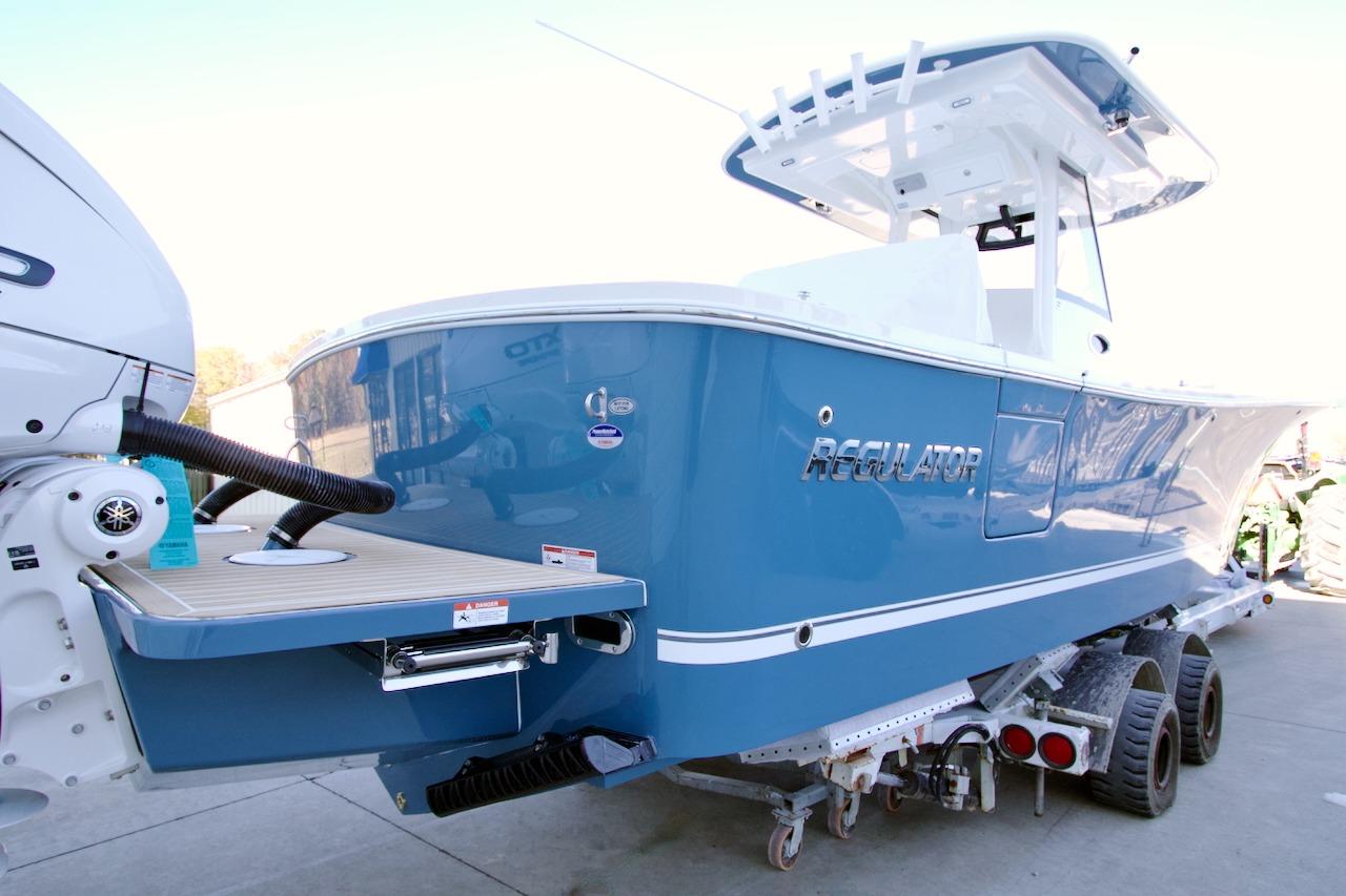 2026 Regulator 31 boat in blue on trailer, rear view.