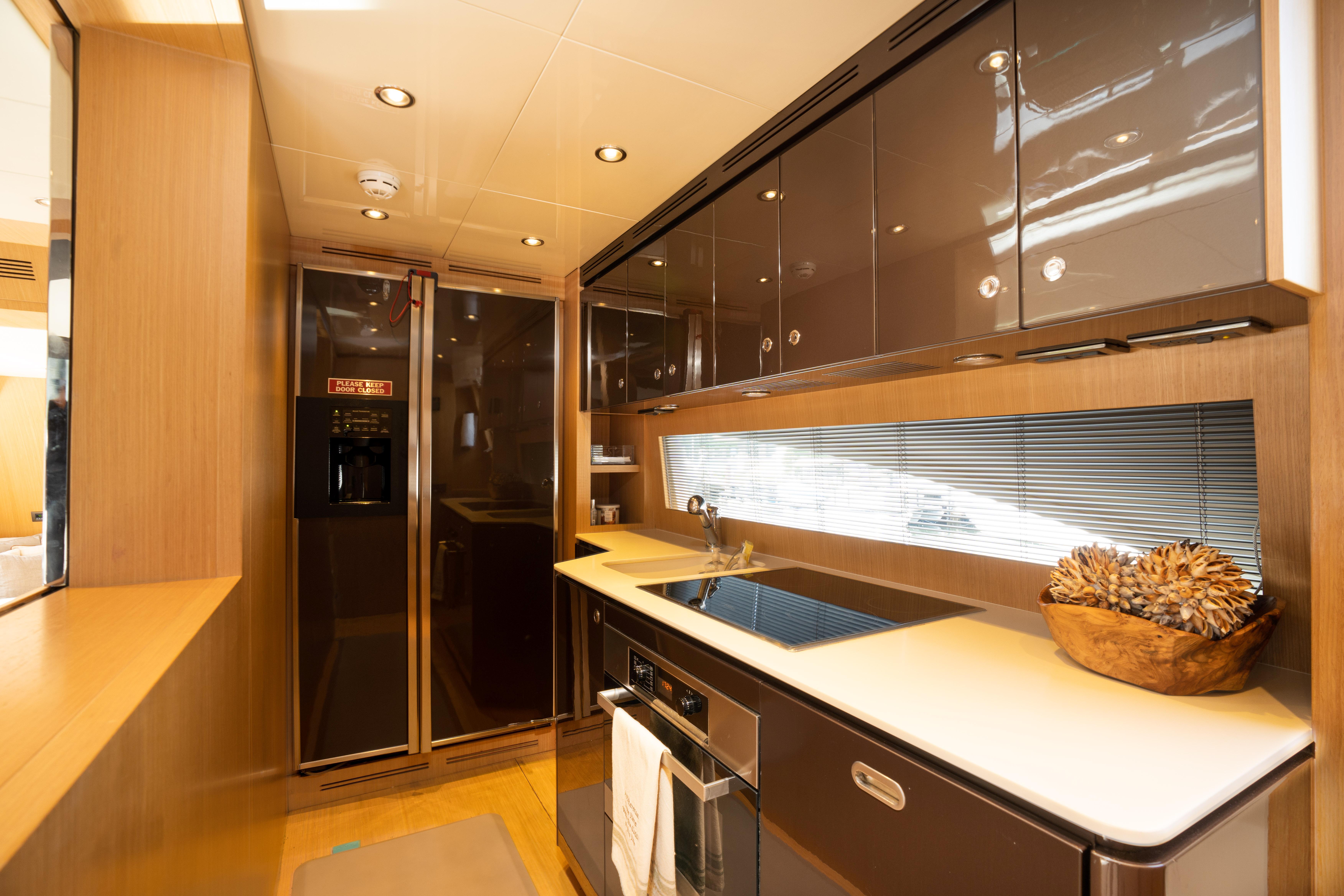 Modern kitchen interior of 2012 Riva 75 Venere yacht with sleek cabinets and appliances.