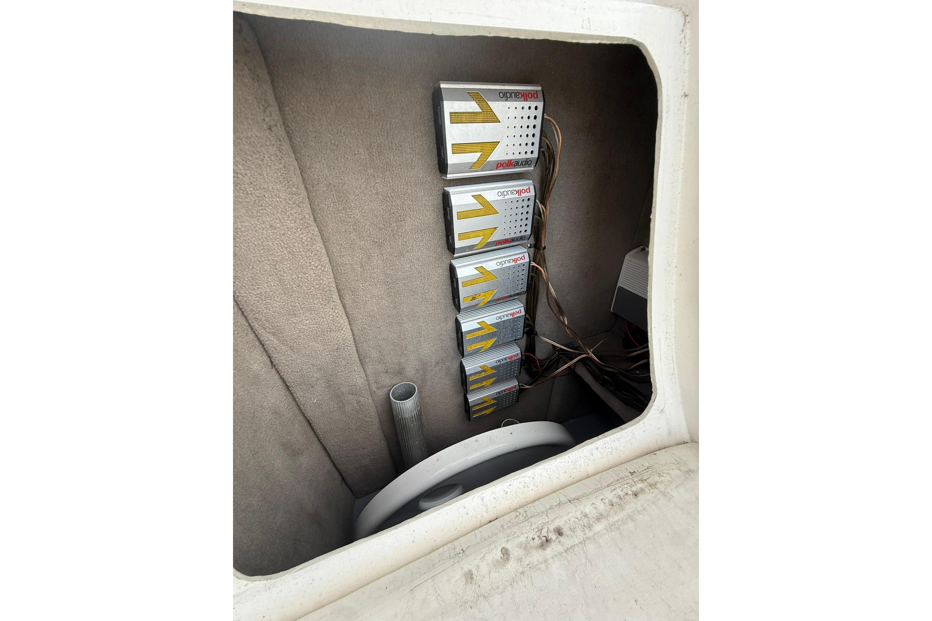 Audio equipment installation inside a 2005 Sea Ray 290 SLX boat compartment.