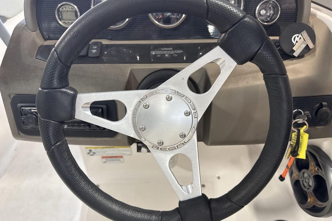 Steering wheel of a 2012 Regal 1900 Bowrider boat with dashboard controls.