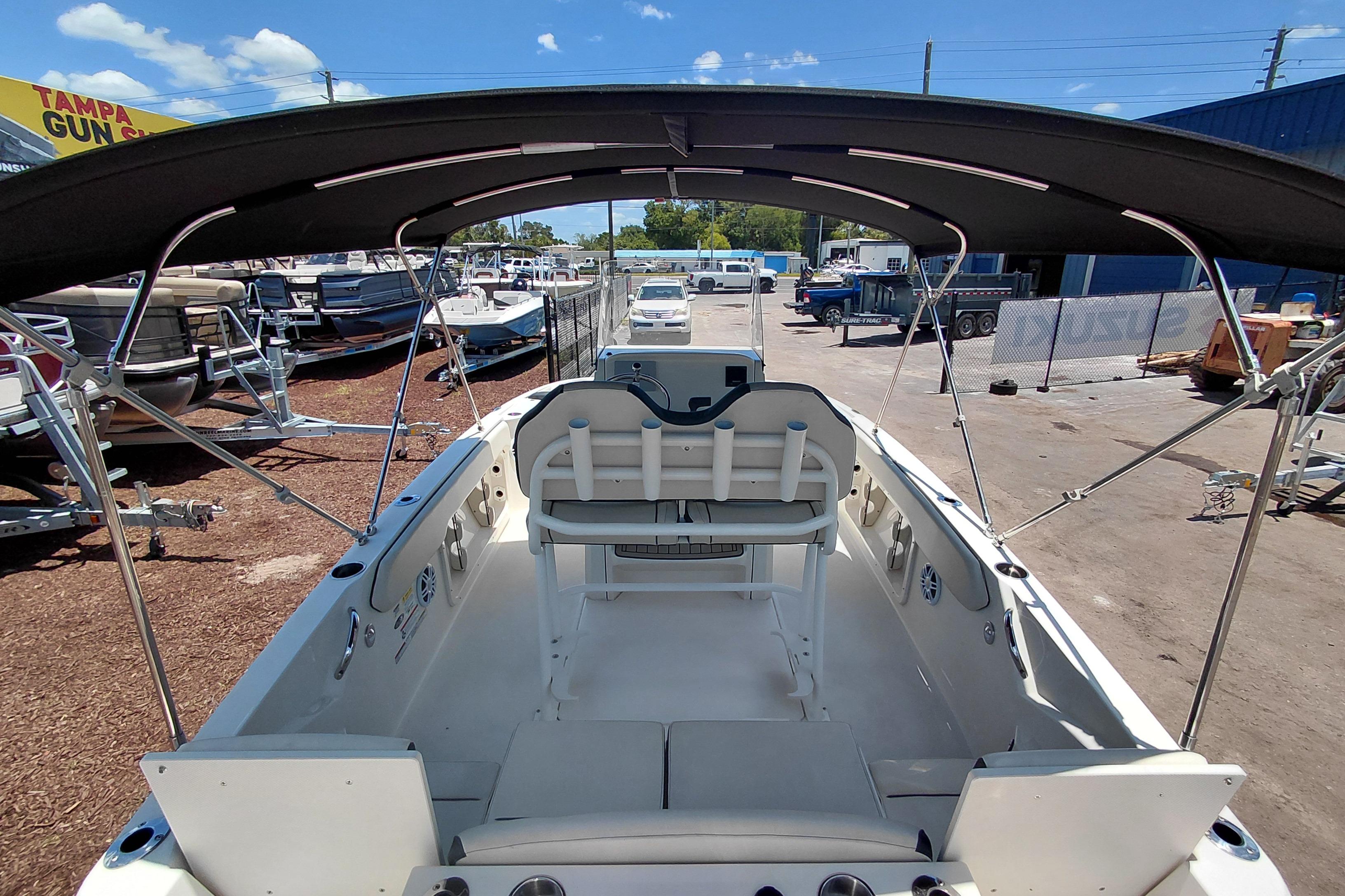 2023 Stingray 206 CC boat interior with canopy, parked at dealership.
