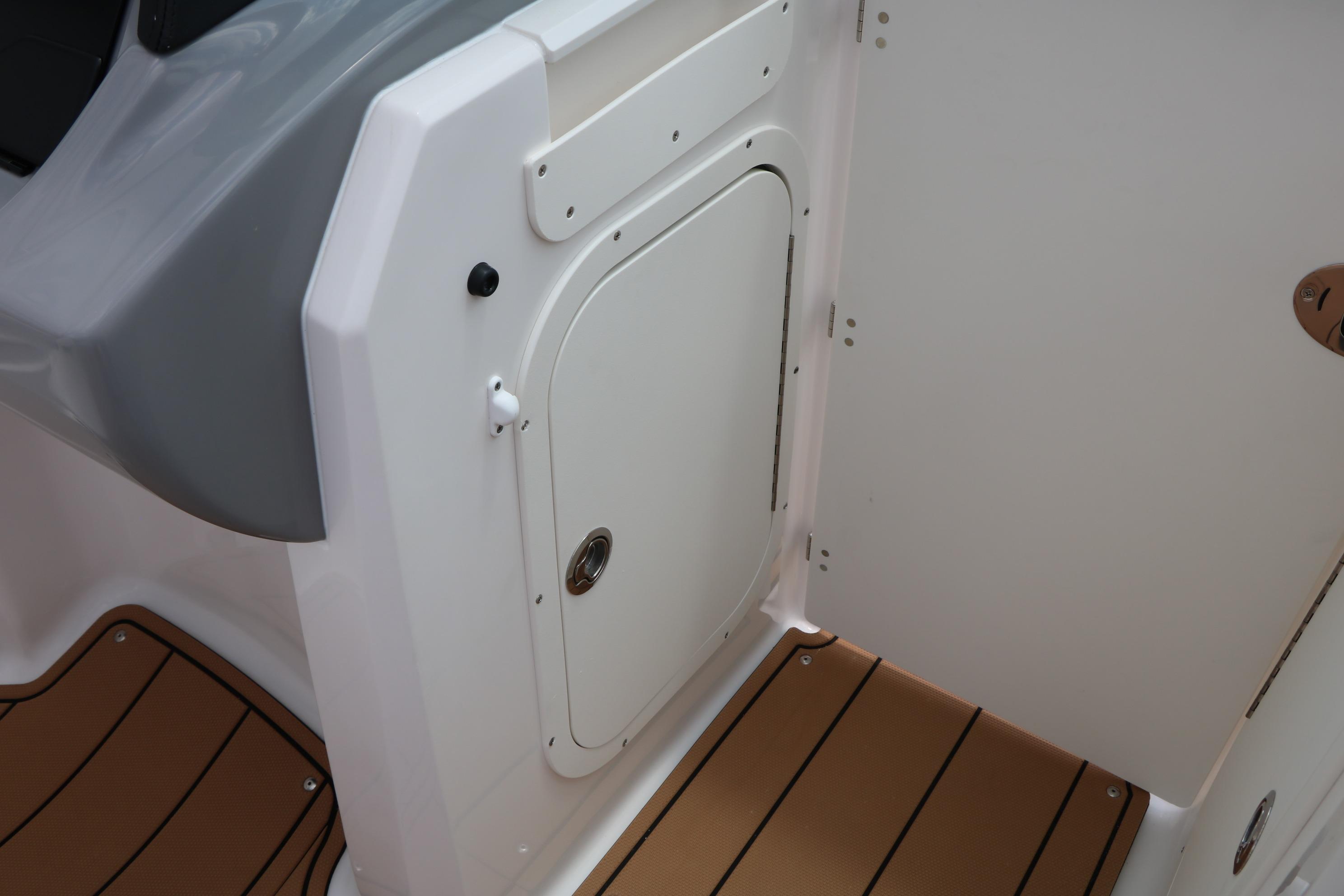 2025 Chaparral 23 SSi boat interior with white hatch and brown flooring.