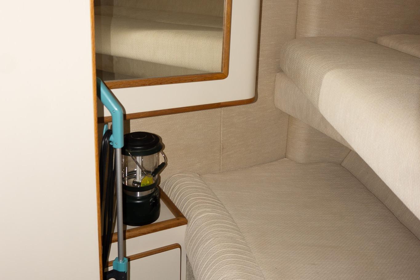 Interior of 1993 Sea Ray 400 Express Cruiser with beige upholstery and a lantern.