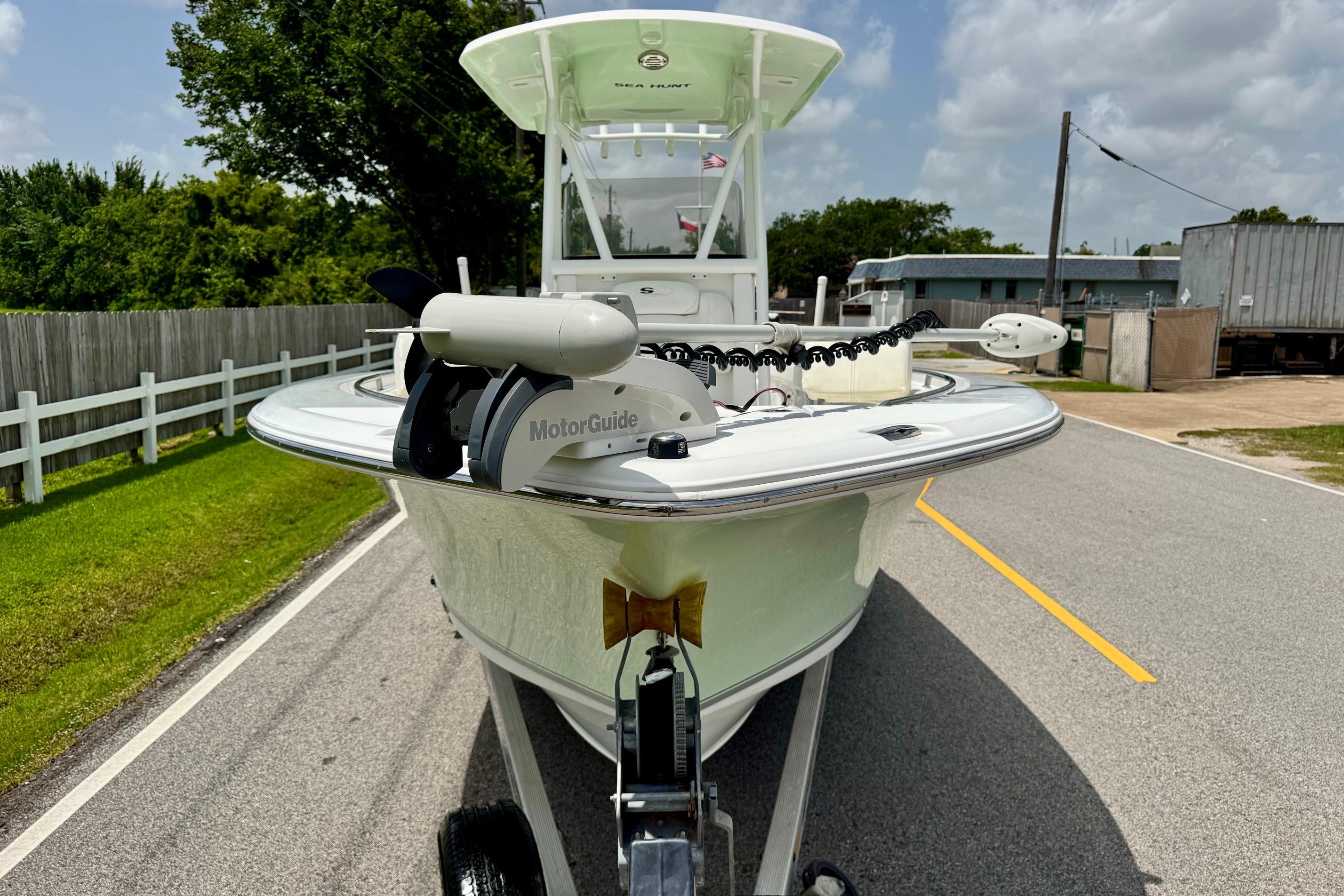 2015 Sea Hunt Ultra 234 boat on trailer, featuring MotorGuide trolling motor.