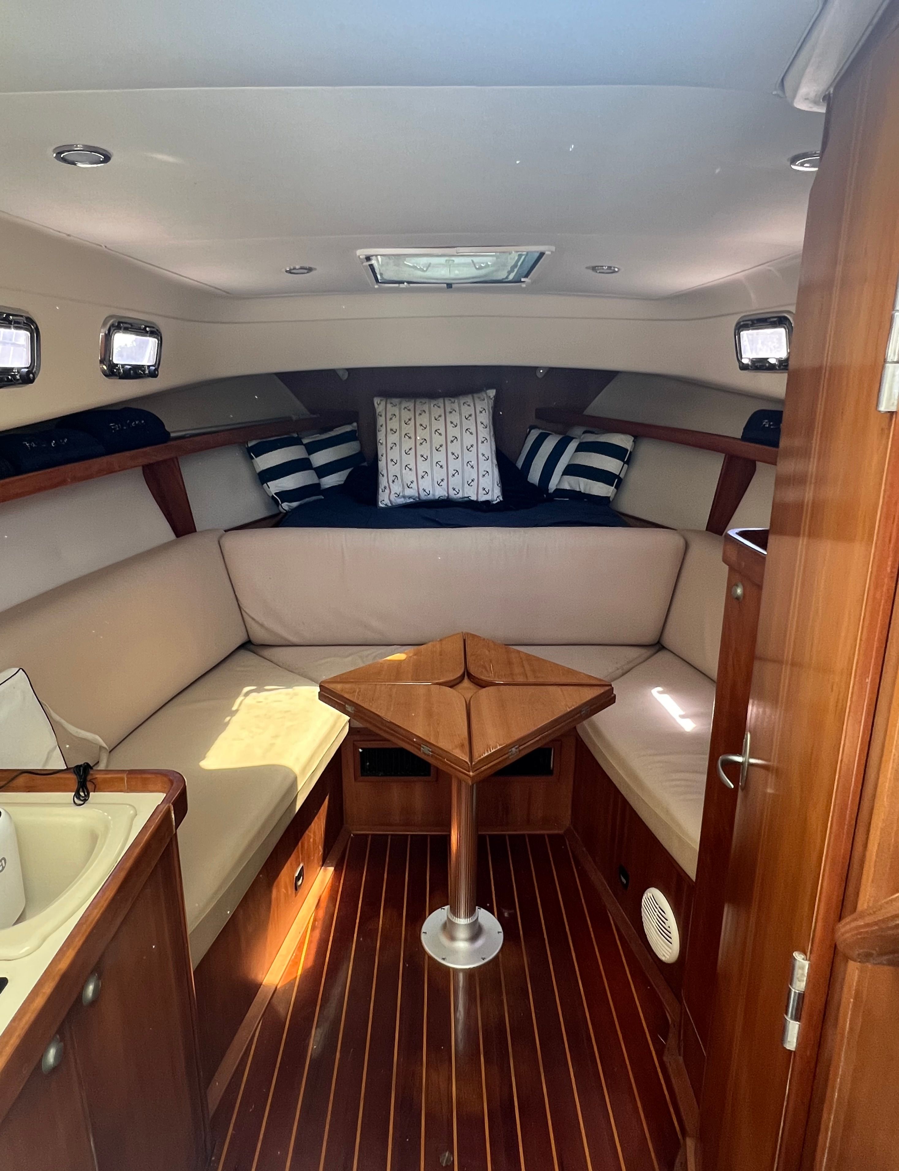 Interior of a 2003 Mainship Pilot 30-II yacht with cozy seating area.