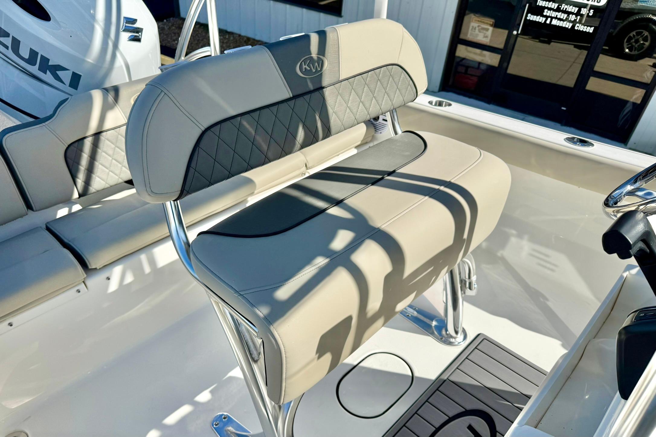 2026 Key West 189 FS boat interior with beige seating and Suzuki engine.