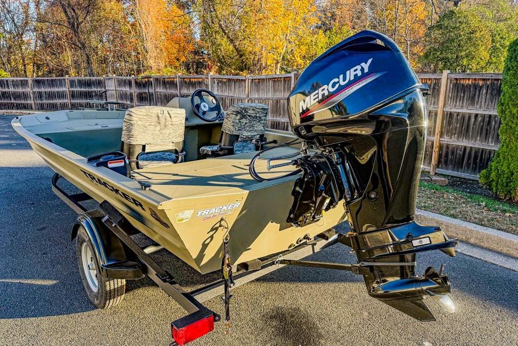 2026 Tracker Grizzly 1754 SC boat with Mercury engine on trailer, autumn background.