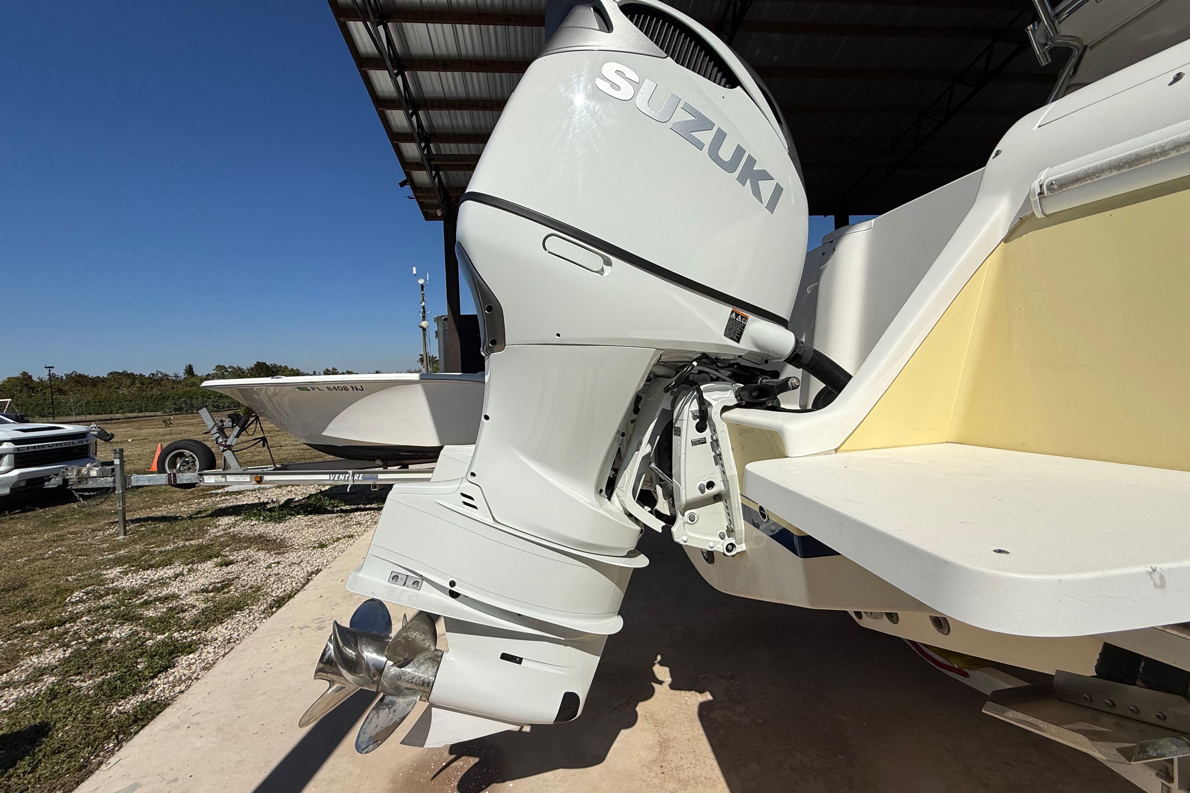 2008 Intrepid 377 Walkaround with Suzuki outboard motor, parked under a metal roof.