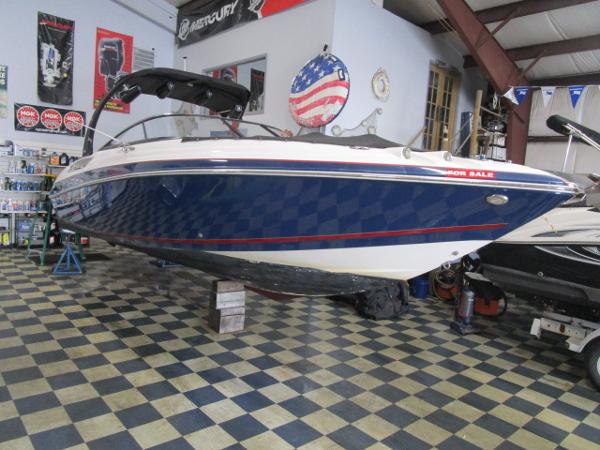 2017 Larson 292 LXI boat displayed indoors on checkered floor.