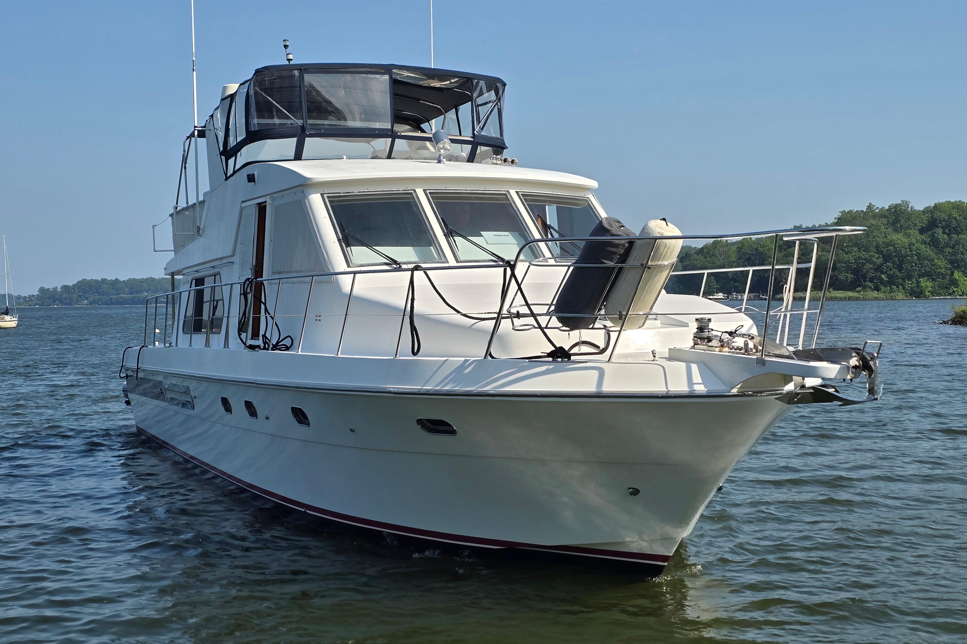 2004 Grand Harbour 58 yacht on calm water, featuring sleek design and spacious deck.