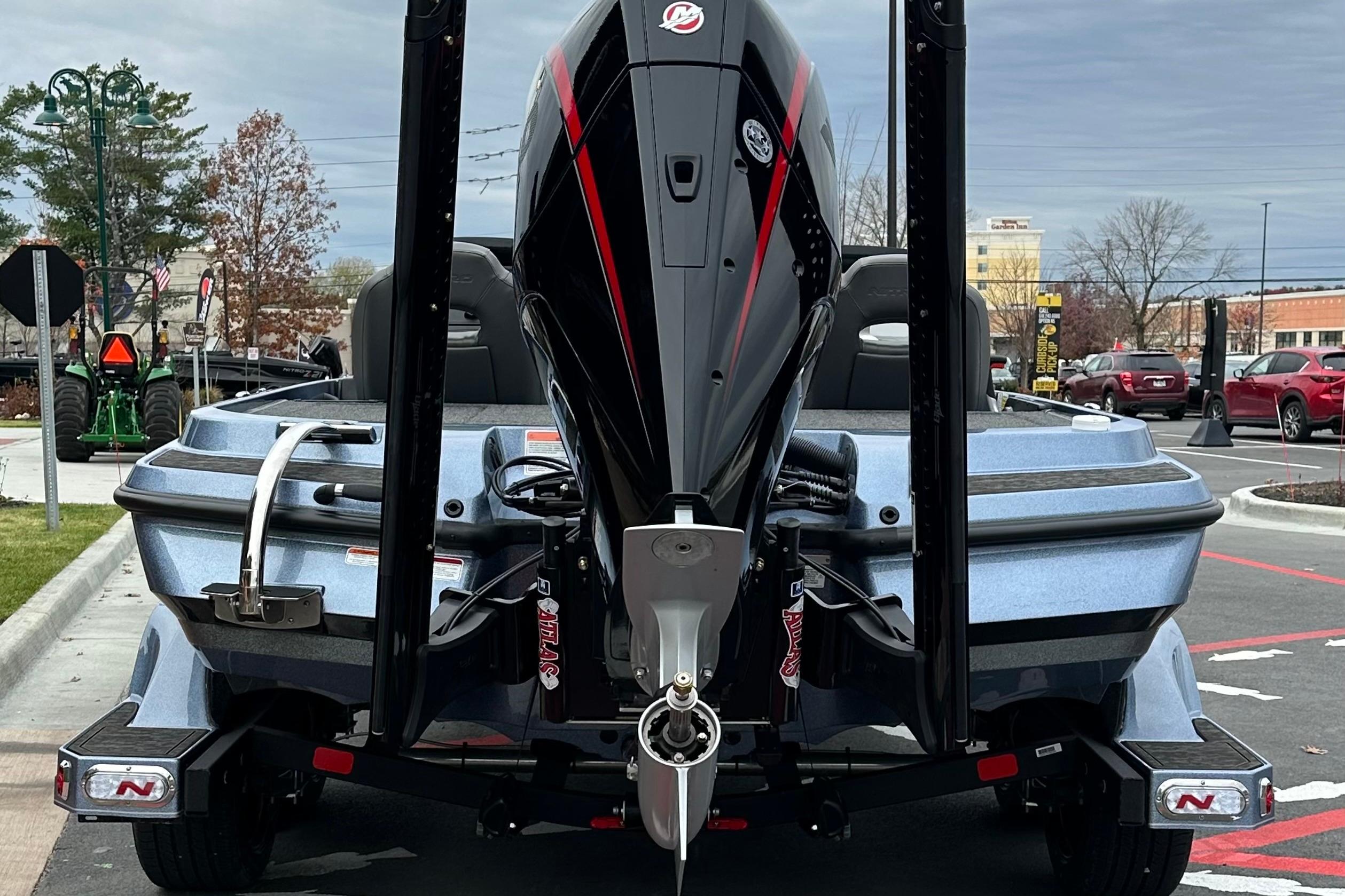 2026 Nitro Z20 XL Pro boat with powerful outboard motor, parked in urban setting.