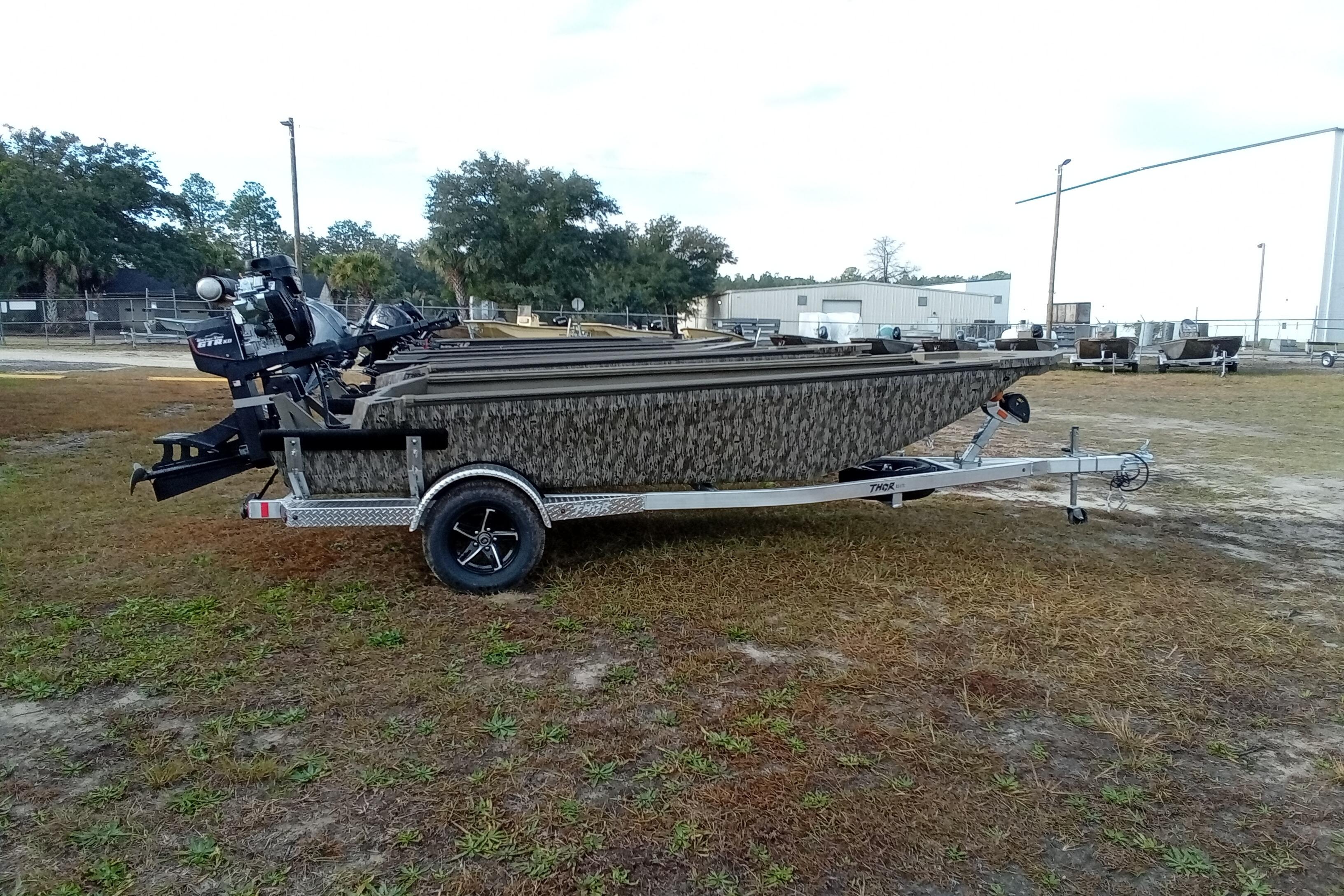 2026 Thor 1754 Swamp Hammer boat on trailer, camo design, parked outdoors.
