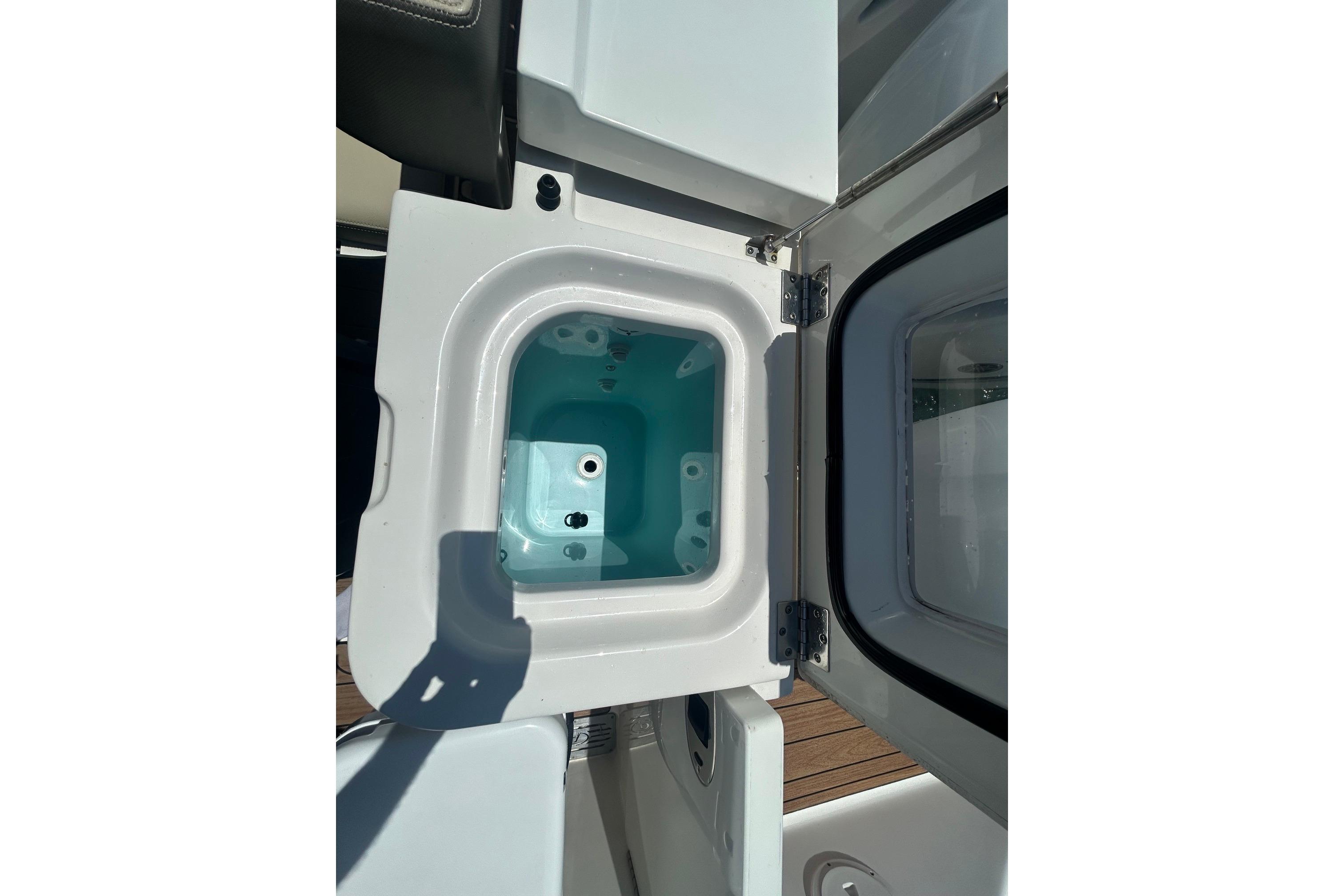 Open storage compartment on 2019 Pursuit OS 355 Offshore boat.