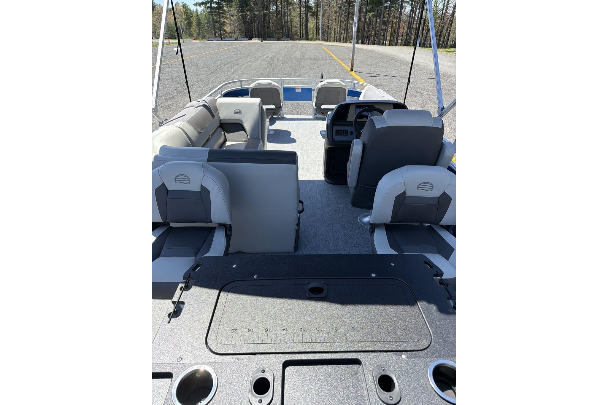 2026 Sun Tracker Fishin' Barge 20 DLX interior with seating and steering console.