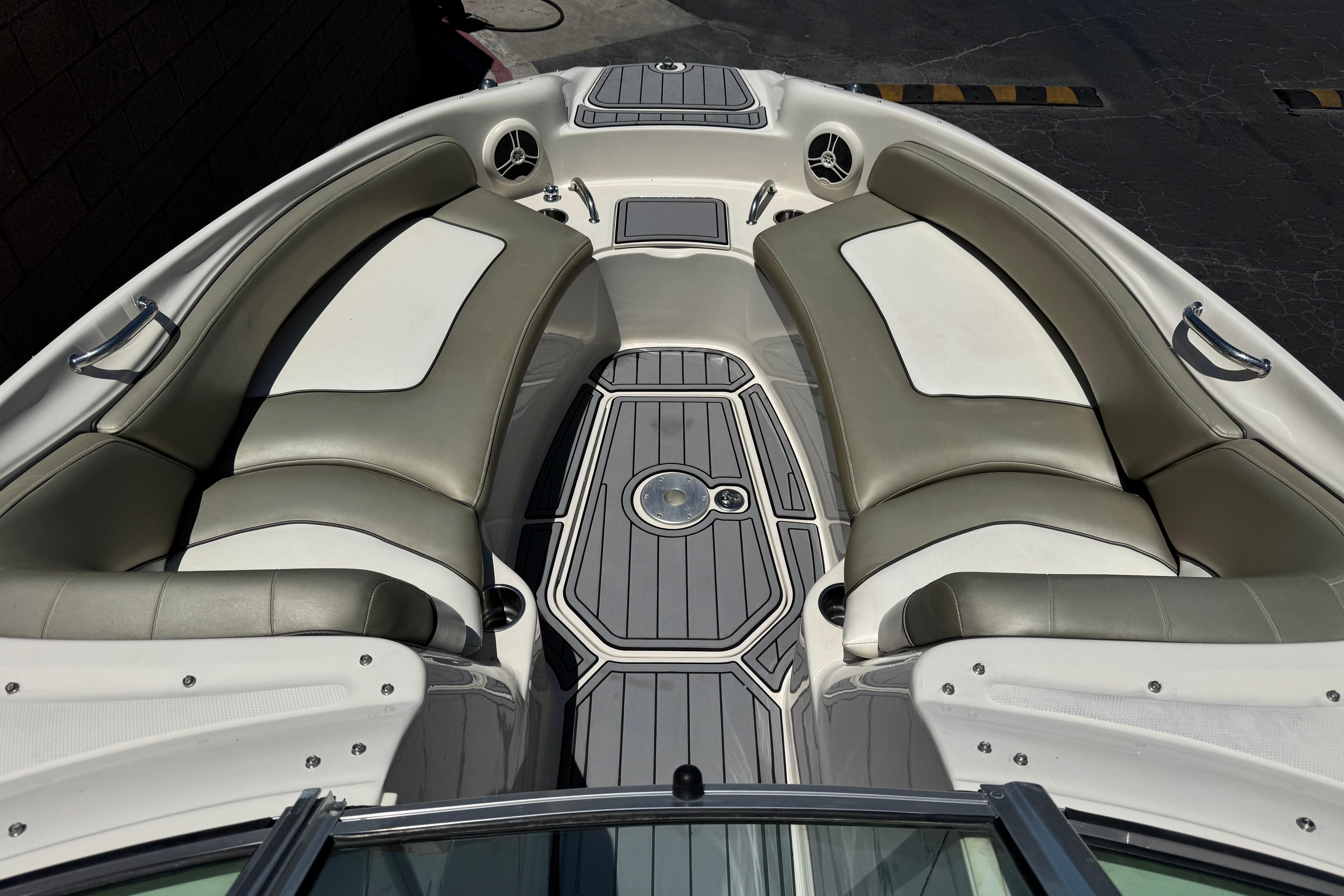 2007 Sea Ray 240 Sundeck interior with cushioned seating and sleek design.
