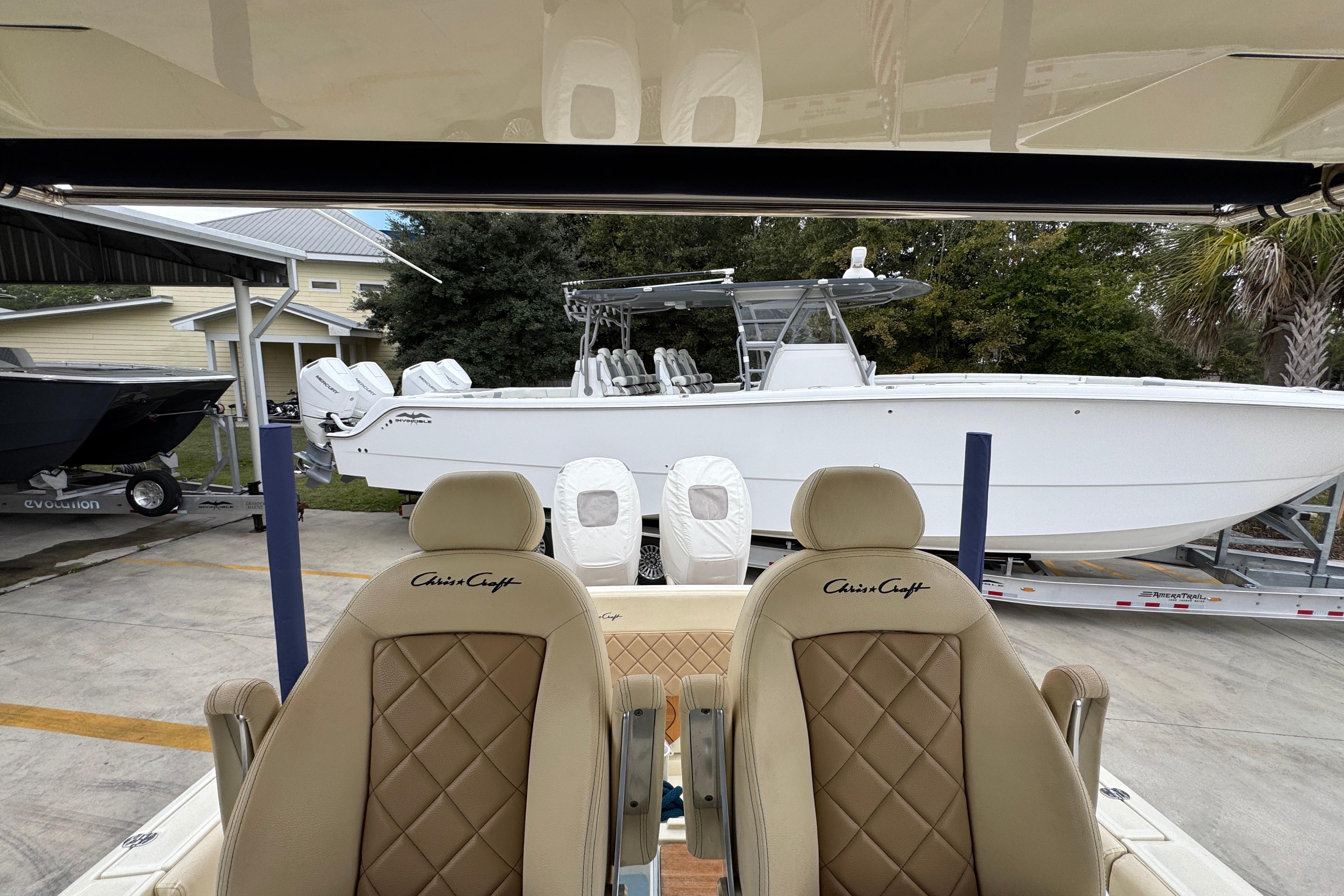 2020 Chris-Craft Catalina 30 boat with luxurious seating, parked outdoors.