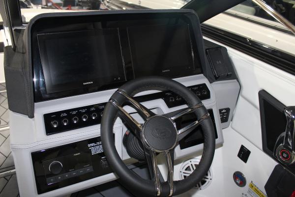 2025 Cobalt R6 boat dashboard with modern steering wheel and dual display screens.