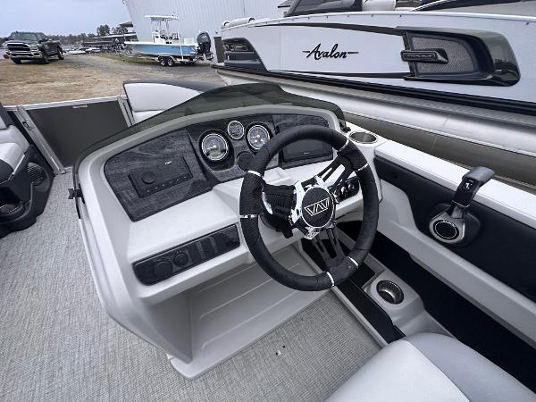 2025 Avalon LSZ Cruise Rear Bench boat interior with modern dashboard and steering wheel.