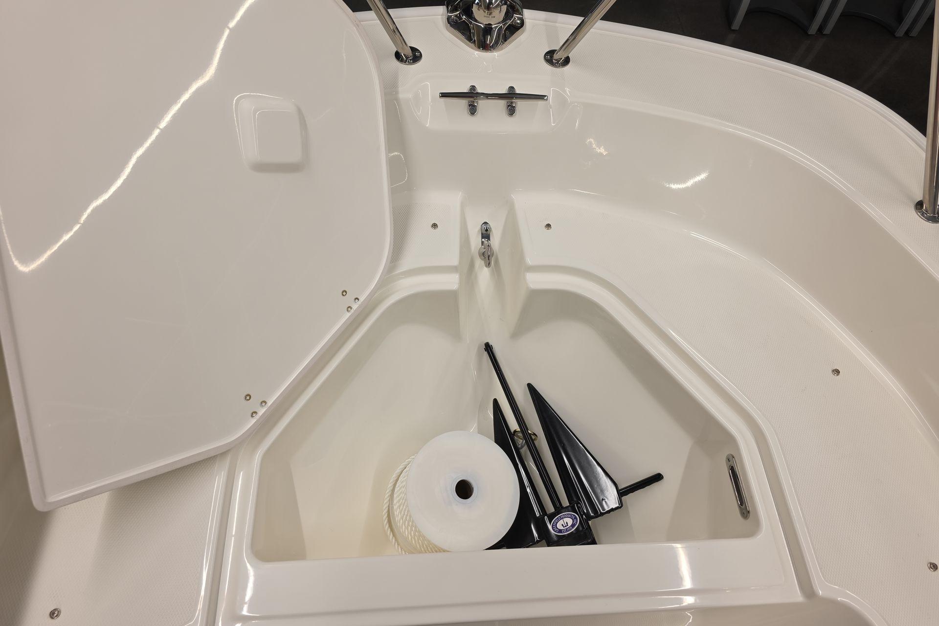 2026 Boston Whaler 150 Montauk boat storage compartment with anchor and rope.