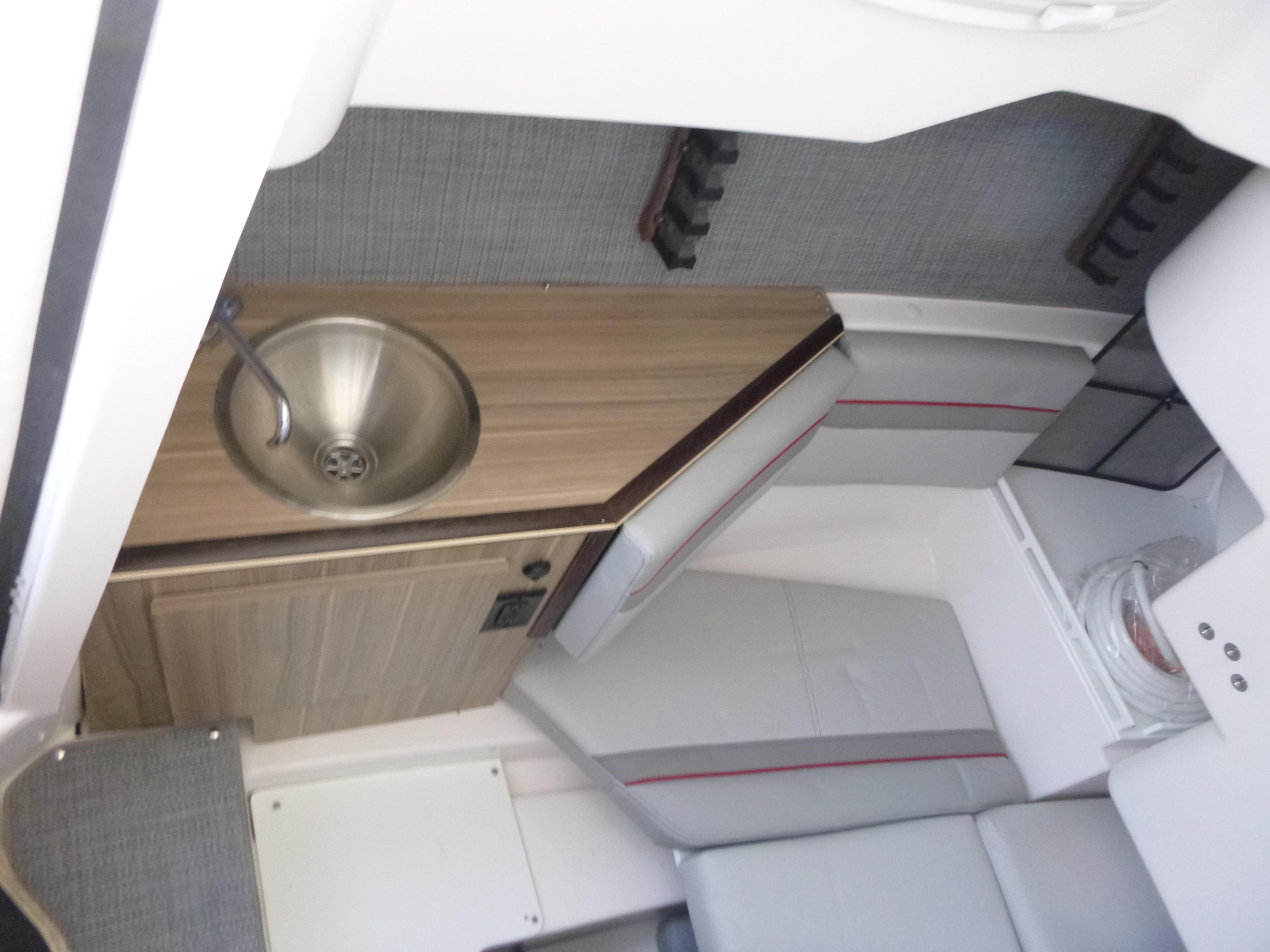 Interior of 2025 Solara S-250 CW boat with sink and seating area.