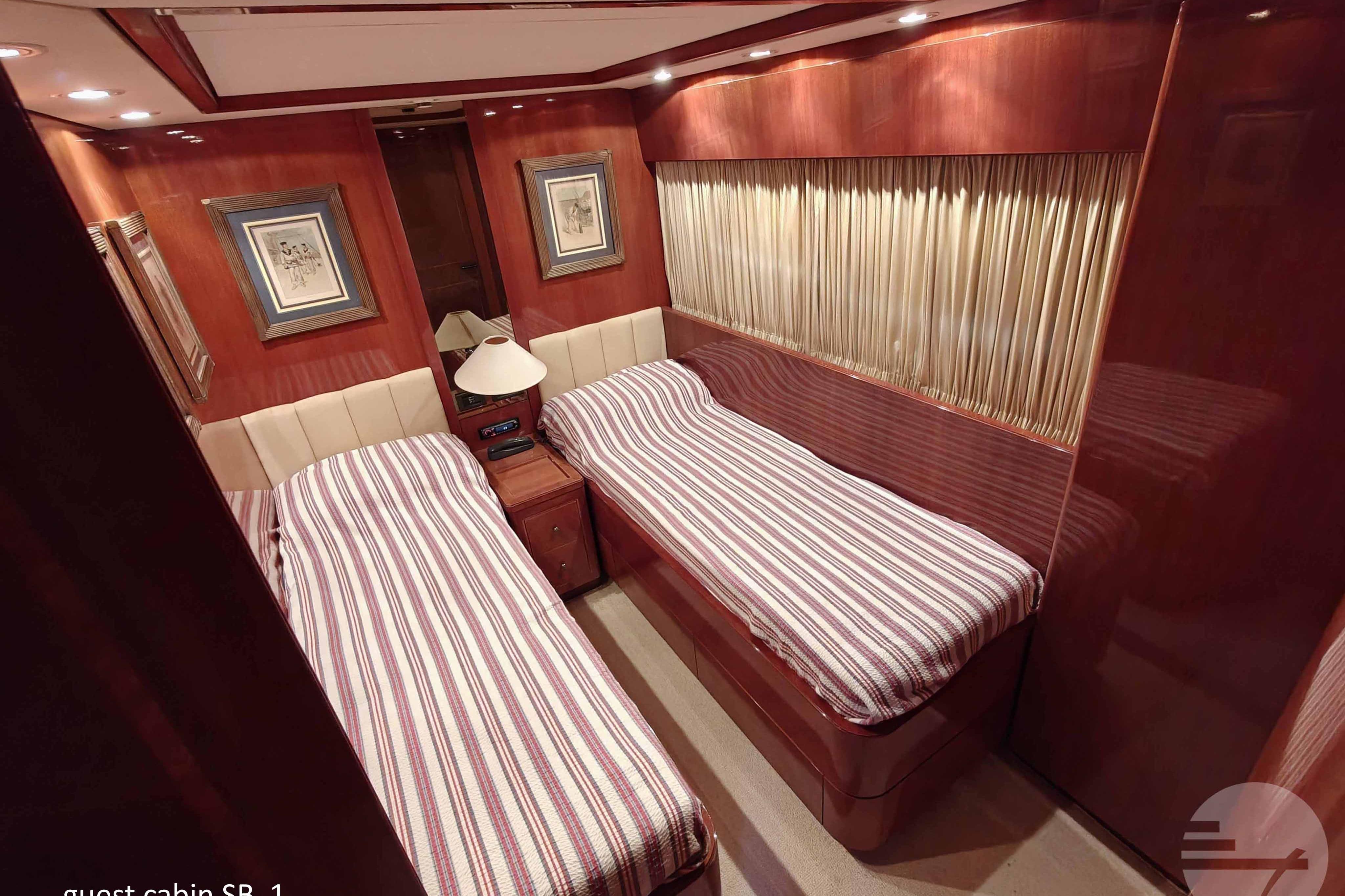 Luxurious guest cabin with twin beds on 1999 Sanlorenzo SL82 yacht.
