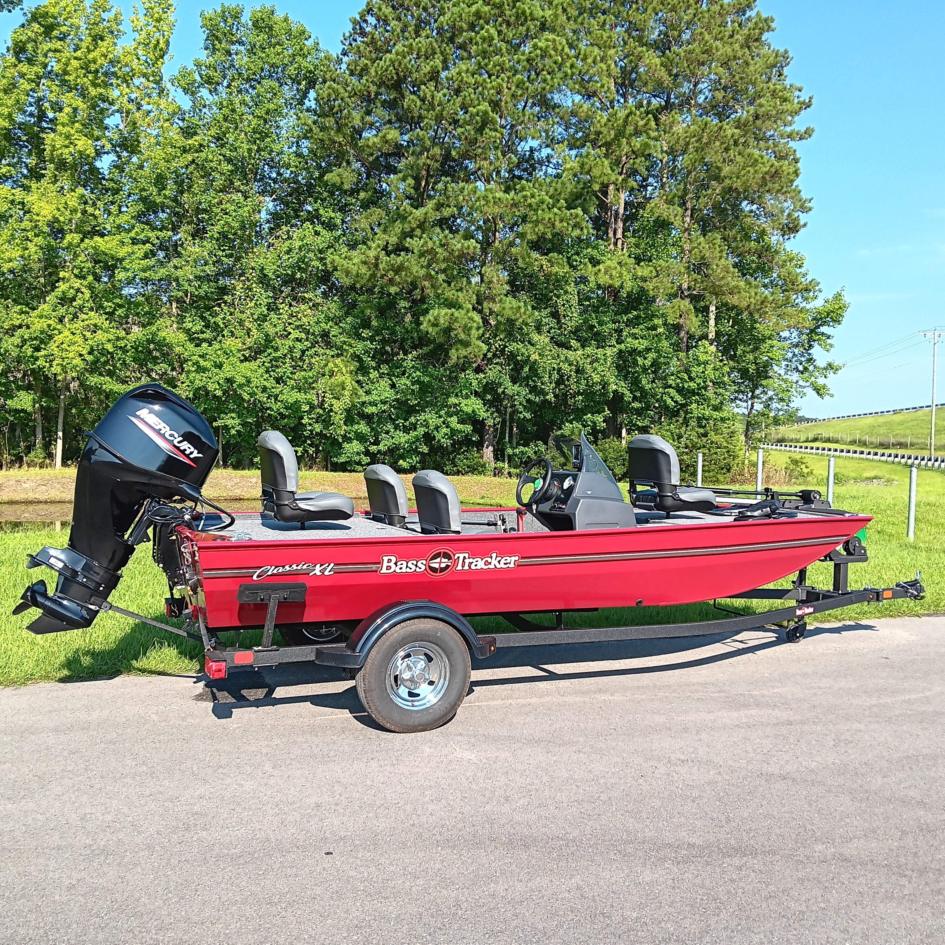 2026 Tracker Bass Tracker Classic XL boat on trailer, parked on road with trees in background.