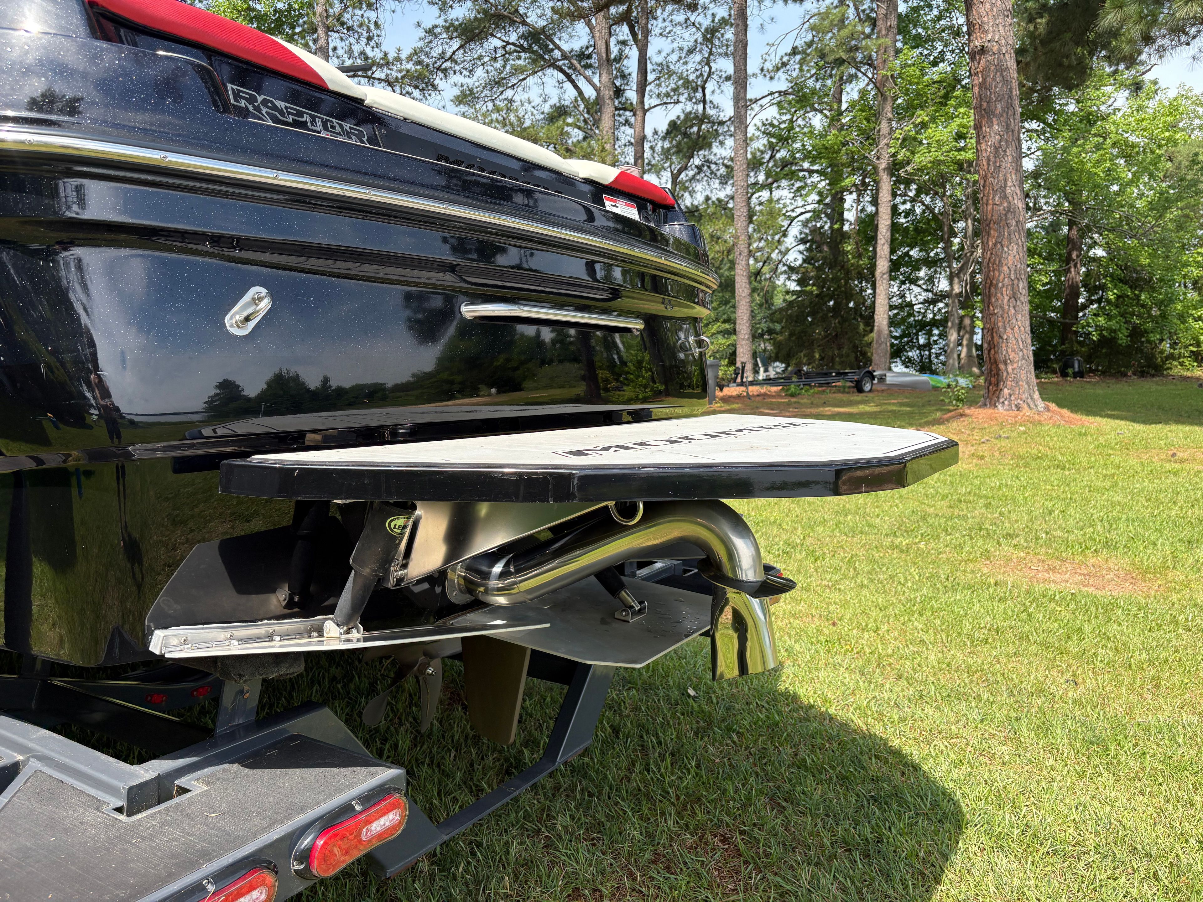2021 Moomba Craz boat with Raptor engine, parked on grass.