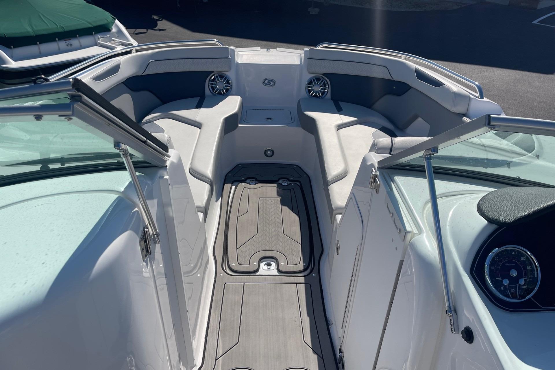 2023 Hurricane SunDeck 2400 OB boat interior with seating and dashboard view.