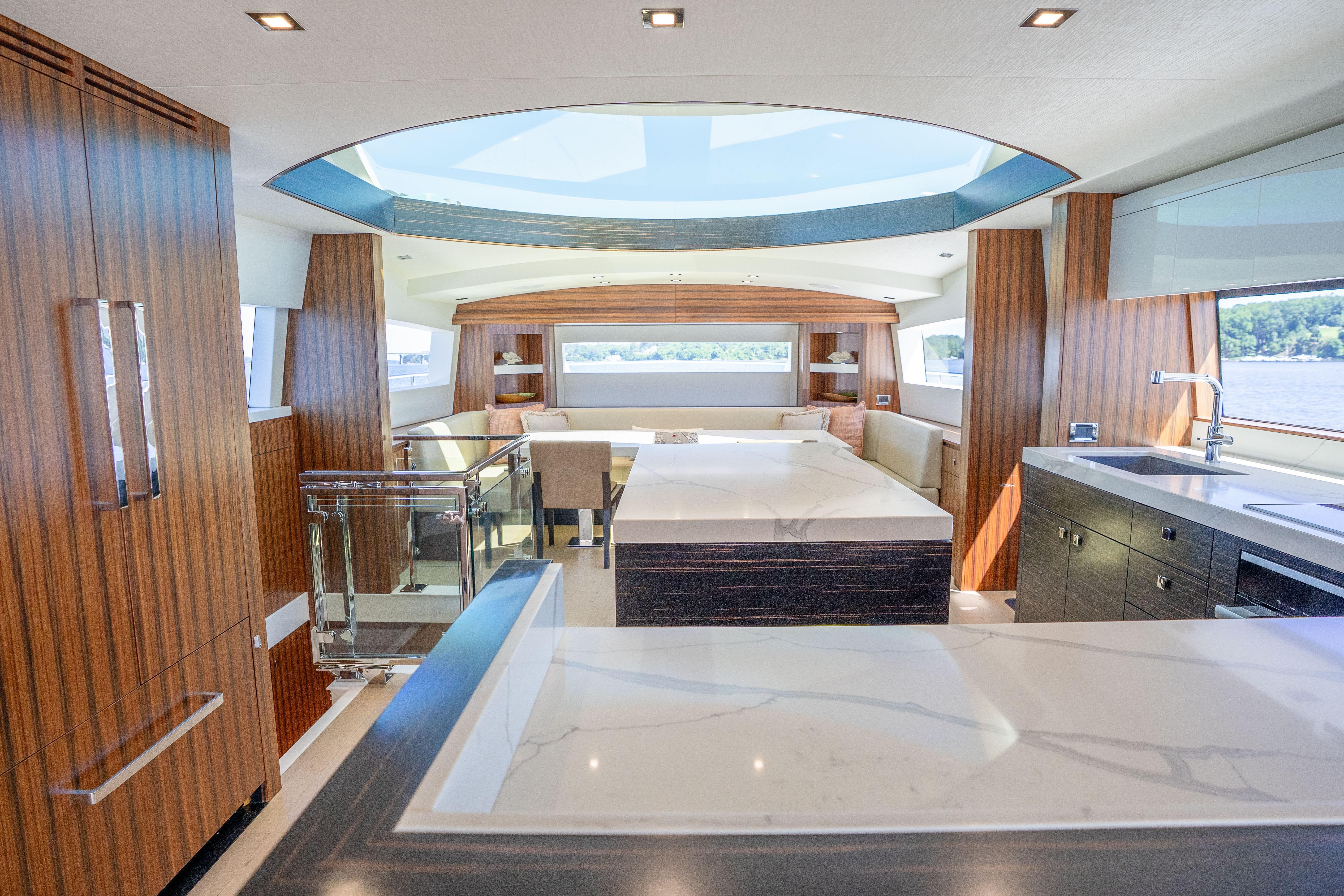 Luxurious interior of 2021 Hatteras M75 Panacera yacht with modern design and skylight.