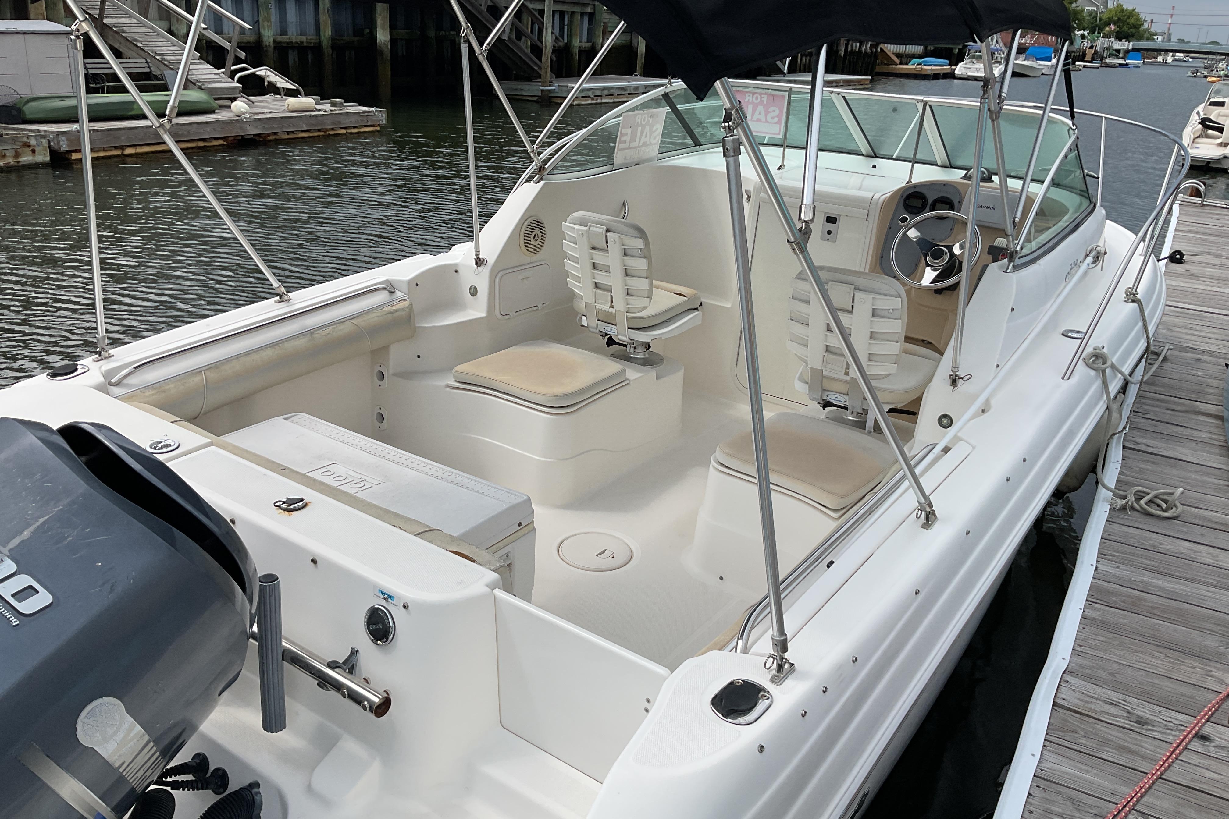2012 Wellcraft 232 Coastal boat docked, featuring spacious seating and modern controls.