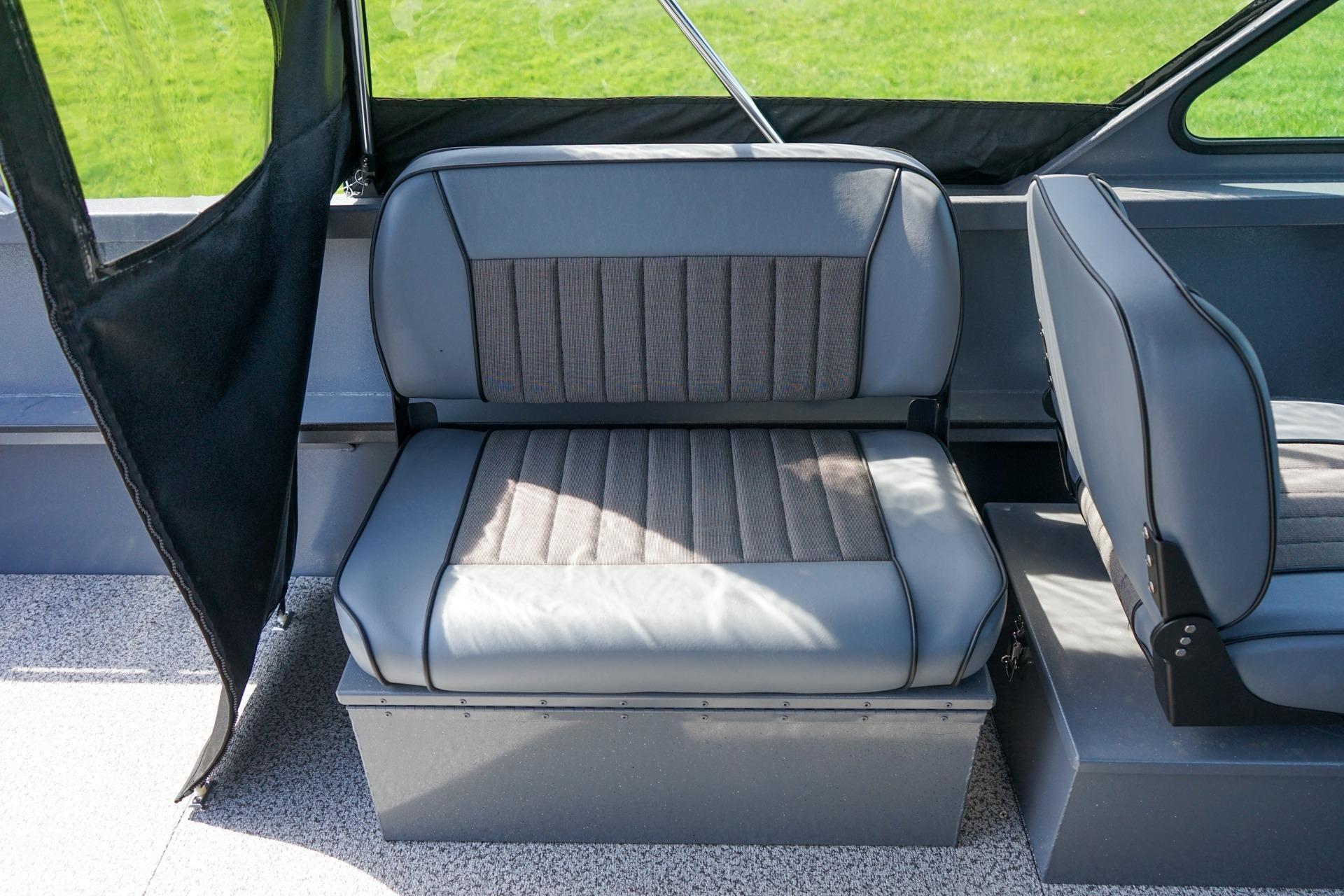 Interior seating of 2026 Alumaweld Talon 18 boat, featuring gray cushioned seats.