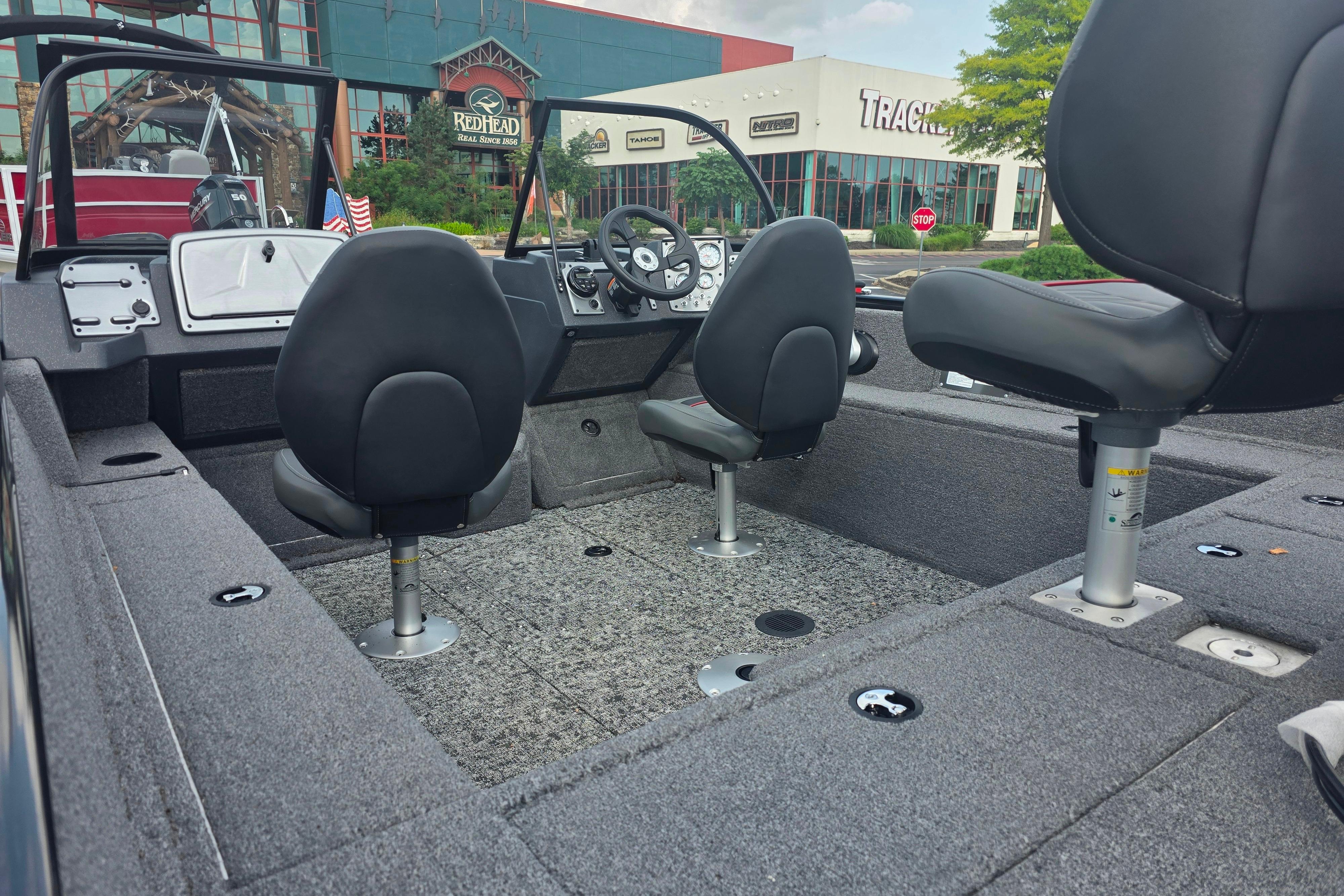 2026 Tracker Pro Guide V-175 Combo boat interior with seating and steering wheel.