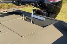 2026 Tracker Grizzly 1654 T Sportsman boat, rear view with motor, outdoors.