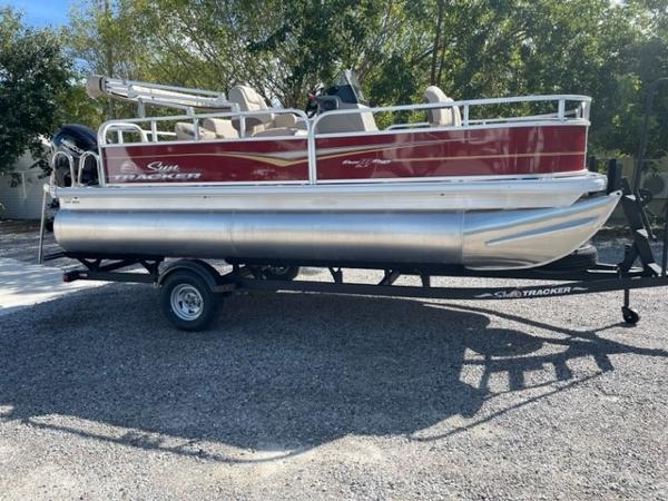 2024 Sun Tracker Bass Buggy 18 DLX pontoon boat on a trailer.