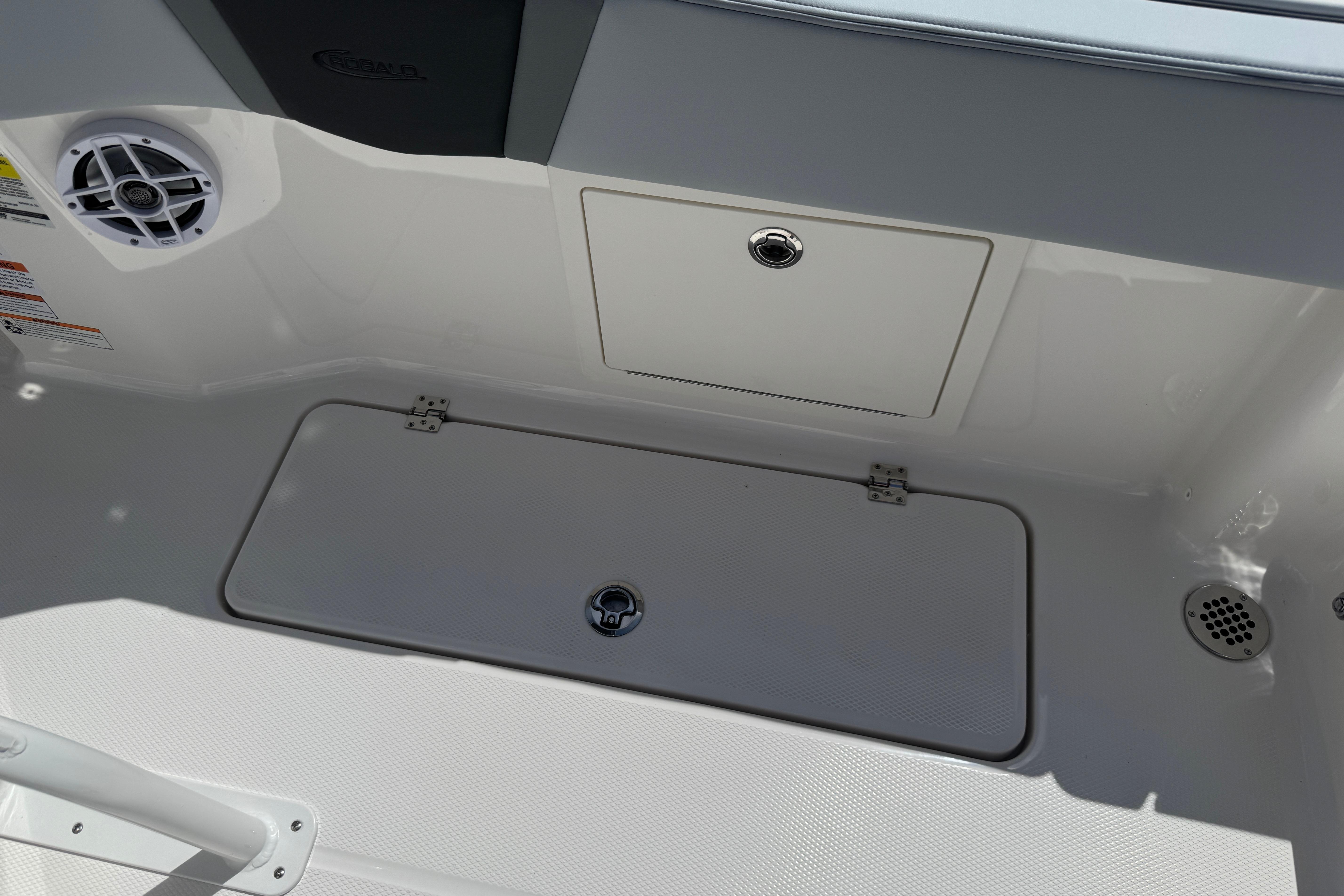 2026 Robalo R250 Center Console boat interior with storage compartments and speaker.