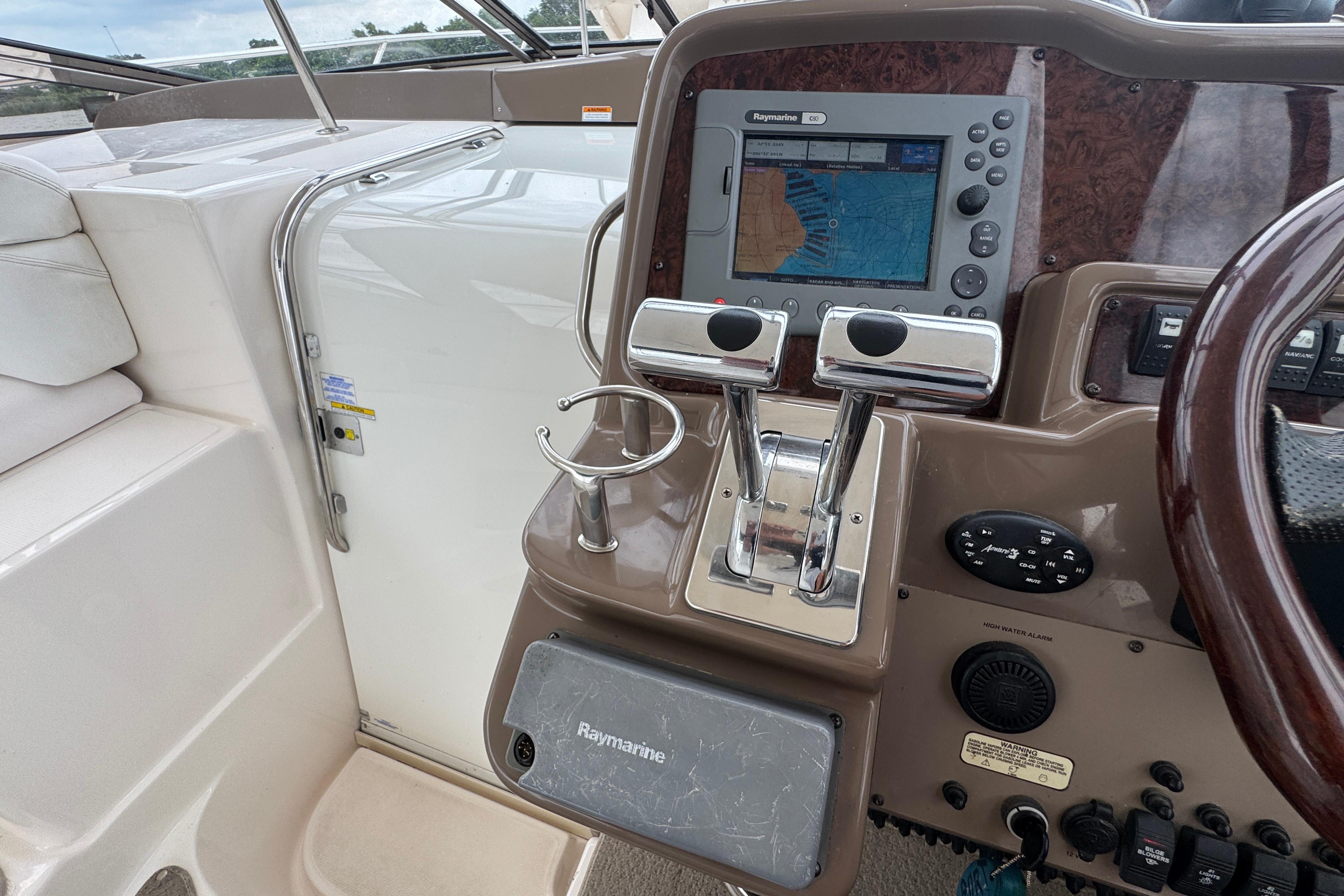 Control panel of a 2005 Regal Commodore 4260 boat with navigation system and throttle controls.