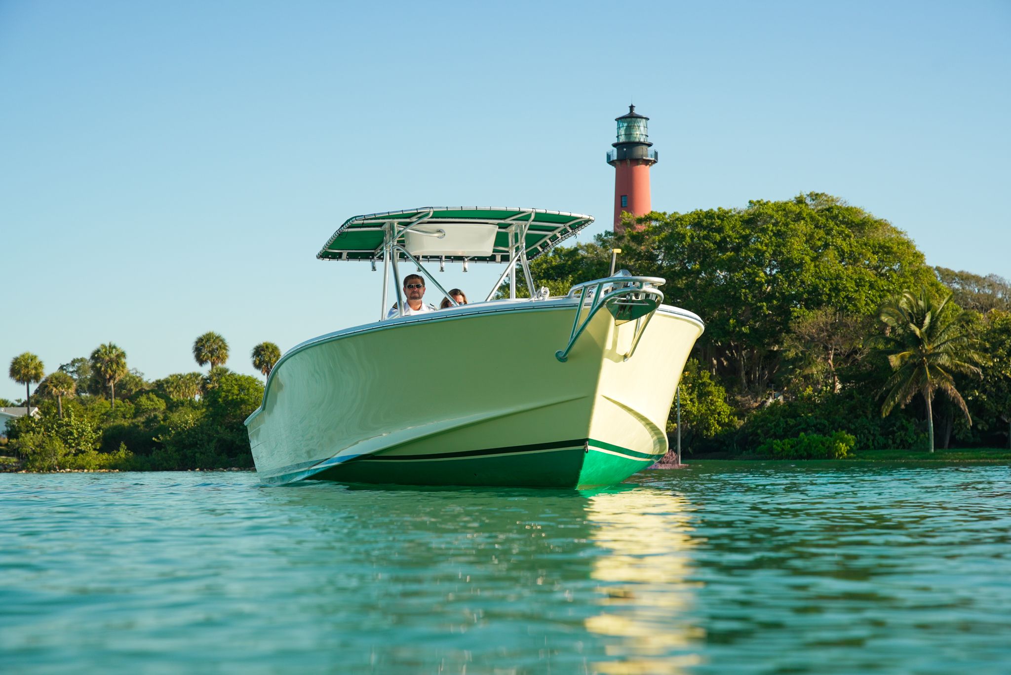 1985 Ocean Master 28 boat near a lighthouse.
